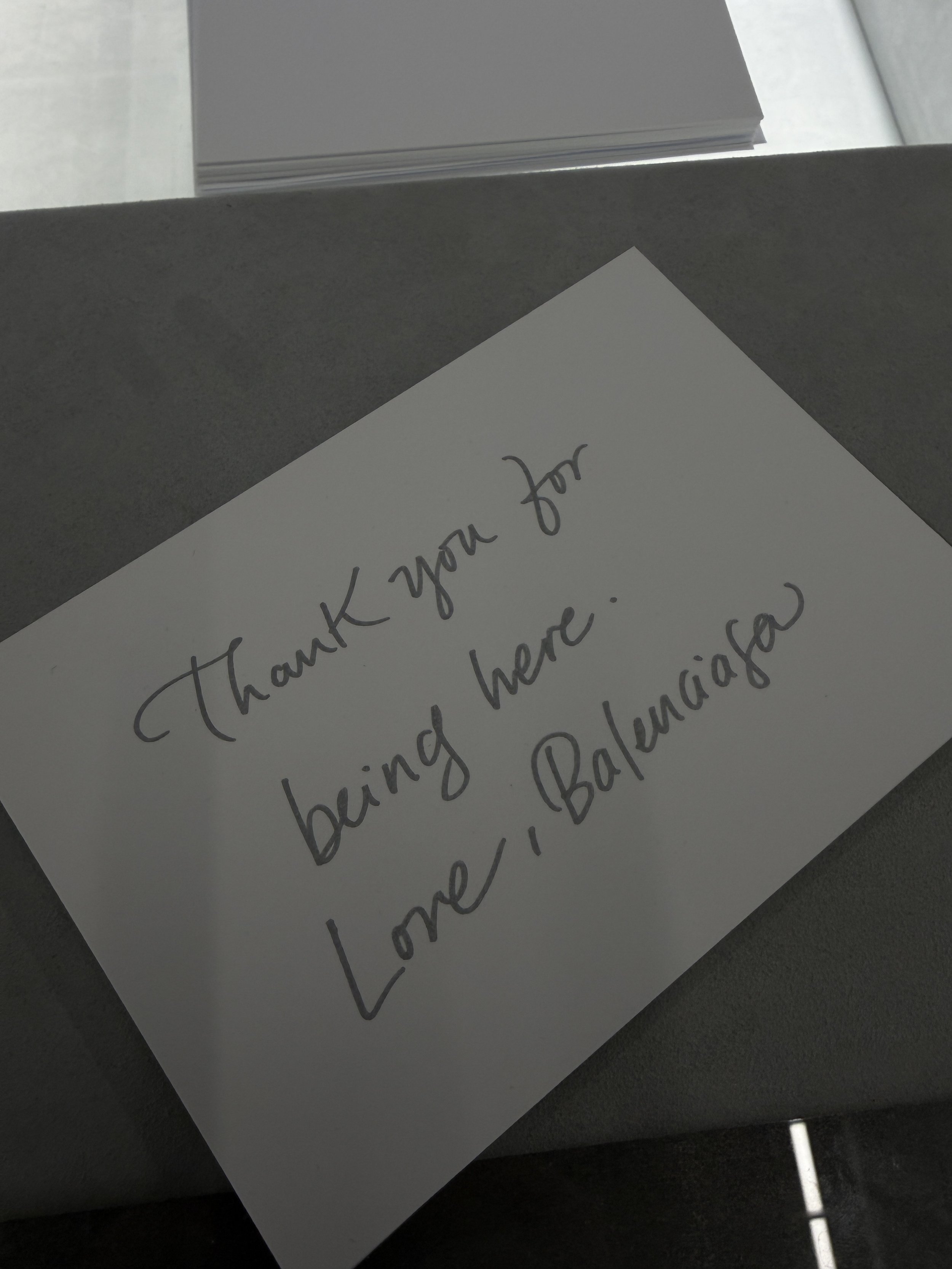 A handwritten thank you note on a piece of white paper with cursive writing.