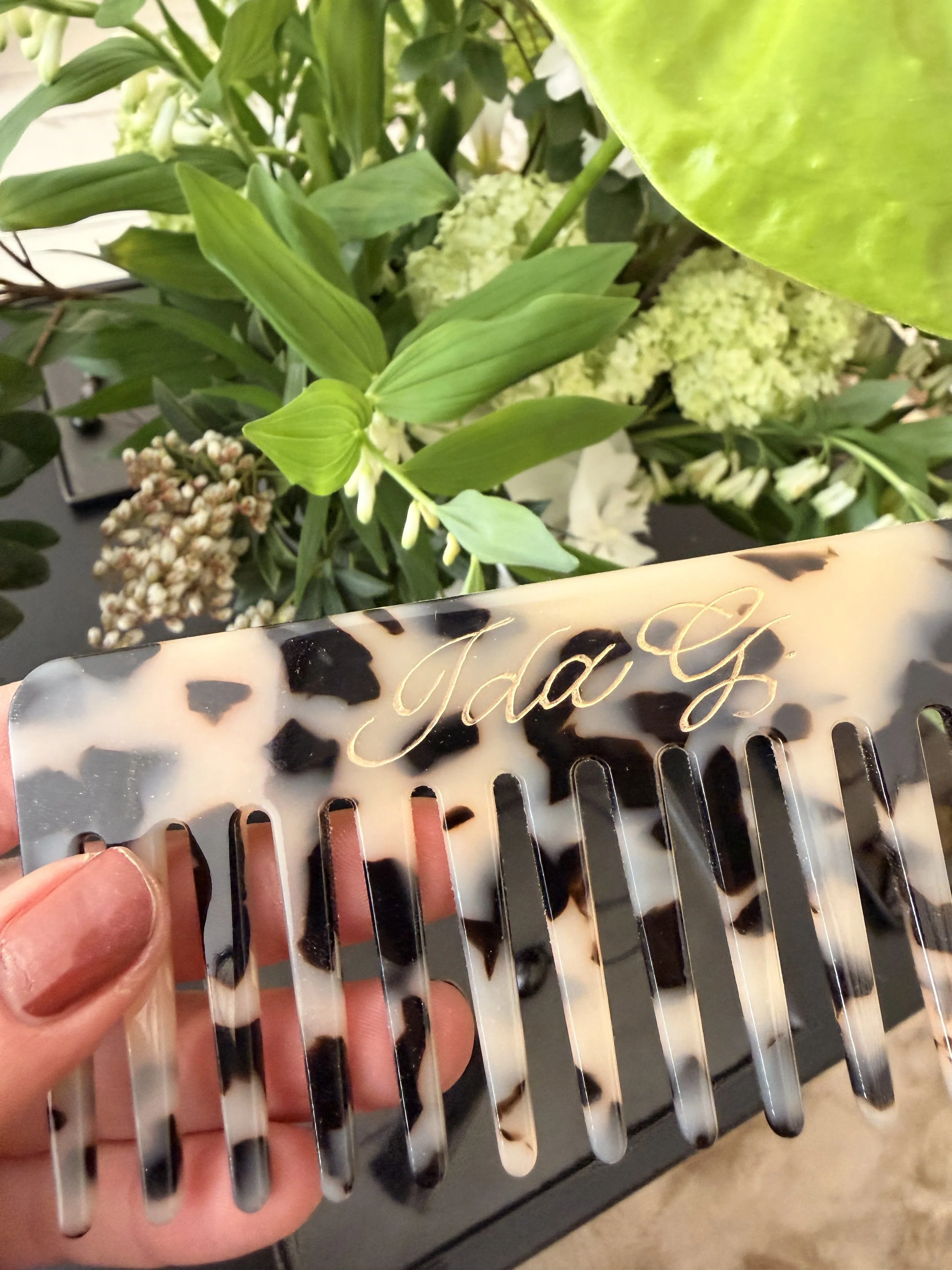 Live engraving a personalised comb at the Nakd pop-up store in Amsterdam