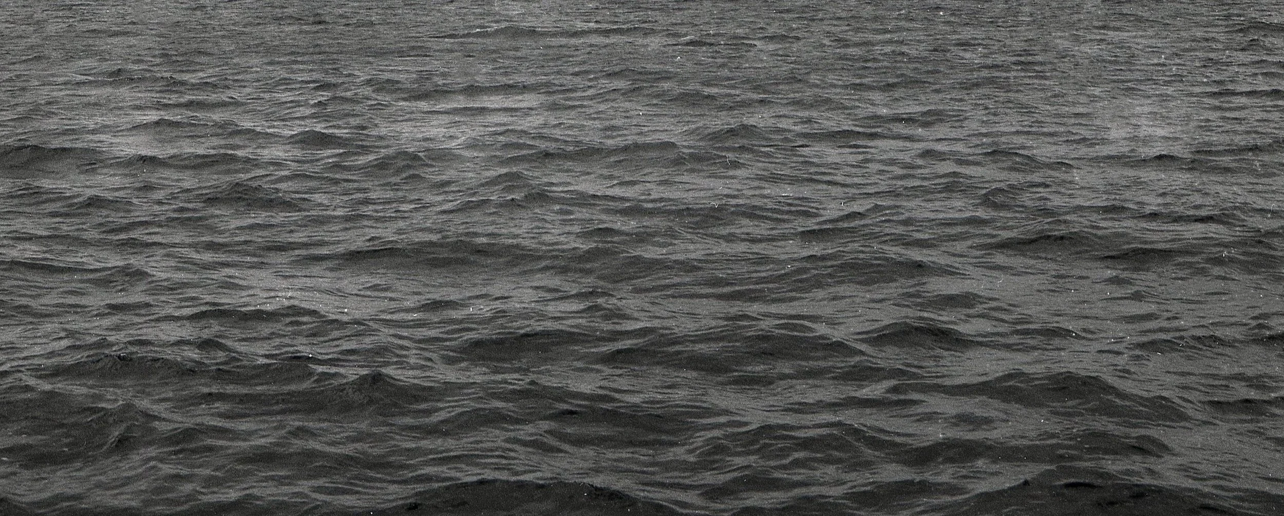 Ocean water with small waves and ripples.