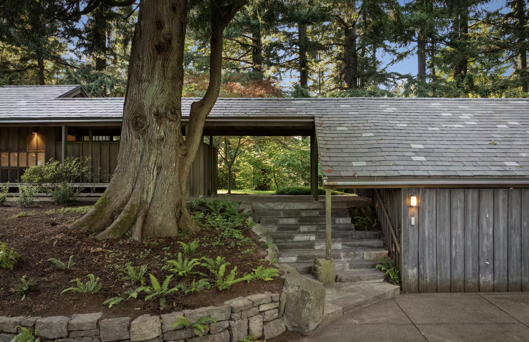John Yeon’s Swan House on SW Fairview Boulevard in Portland’s Sylvan Highlands, with board-and-batten siding and walls of glass facing the forest of Hoyt Arboretum.