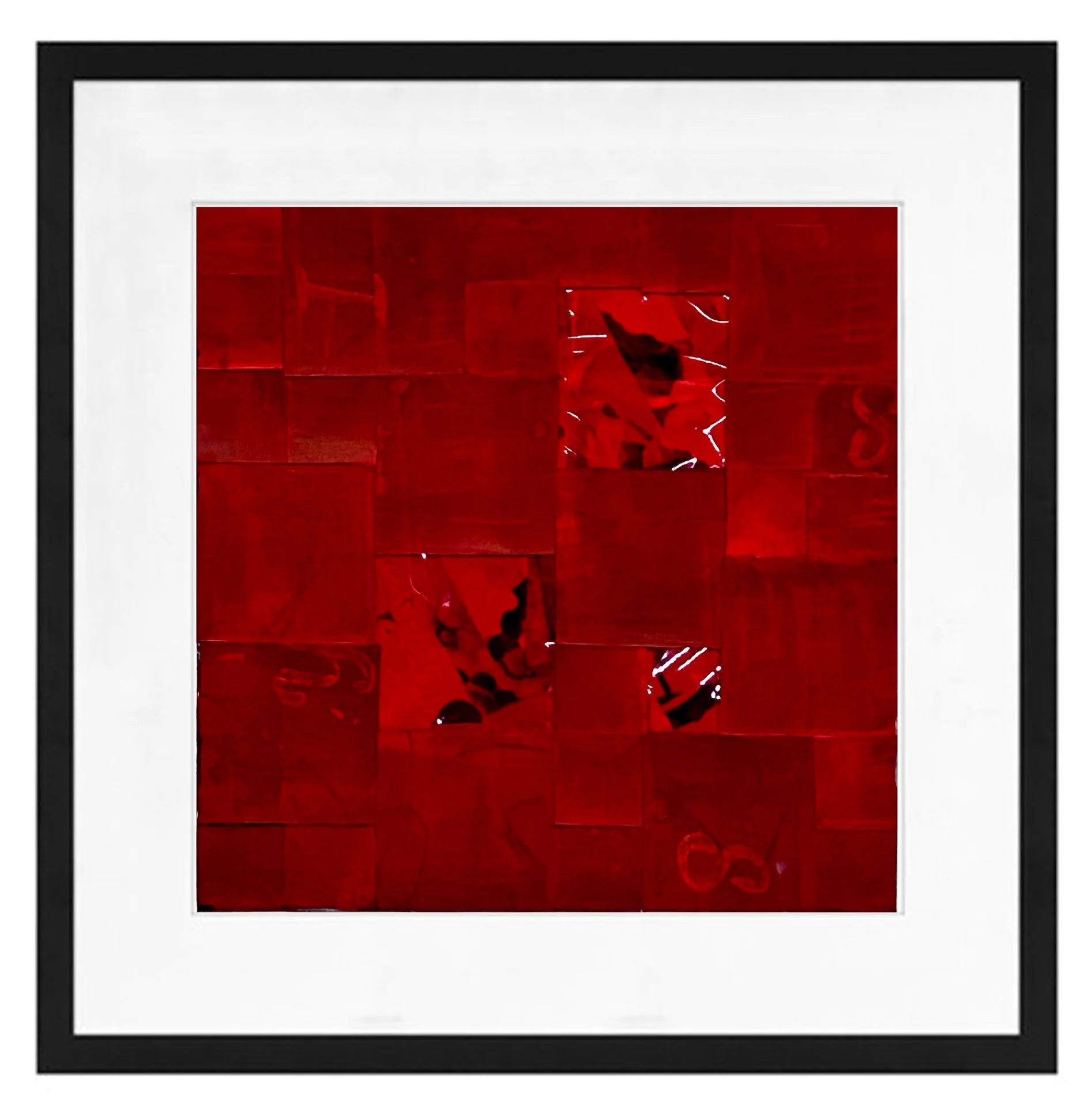 Close-up of a framed picture with a red abstract image inside, surrounded by a black and white border.
