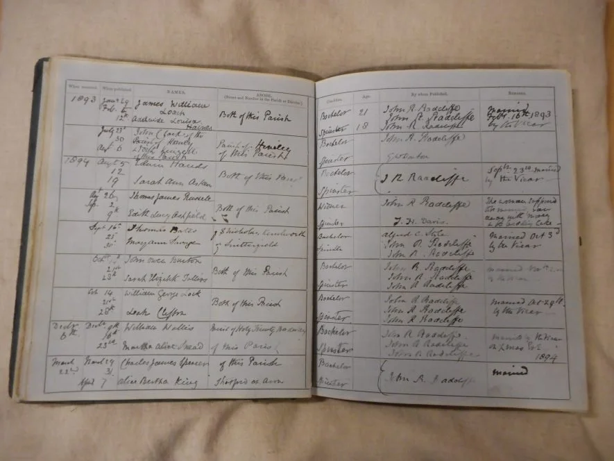An open book showing handwritten genealogical records with names, dates, and relationships, organized in columns at Parnacott house.