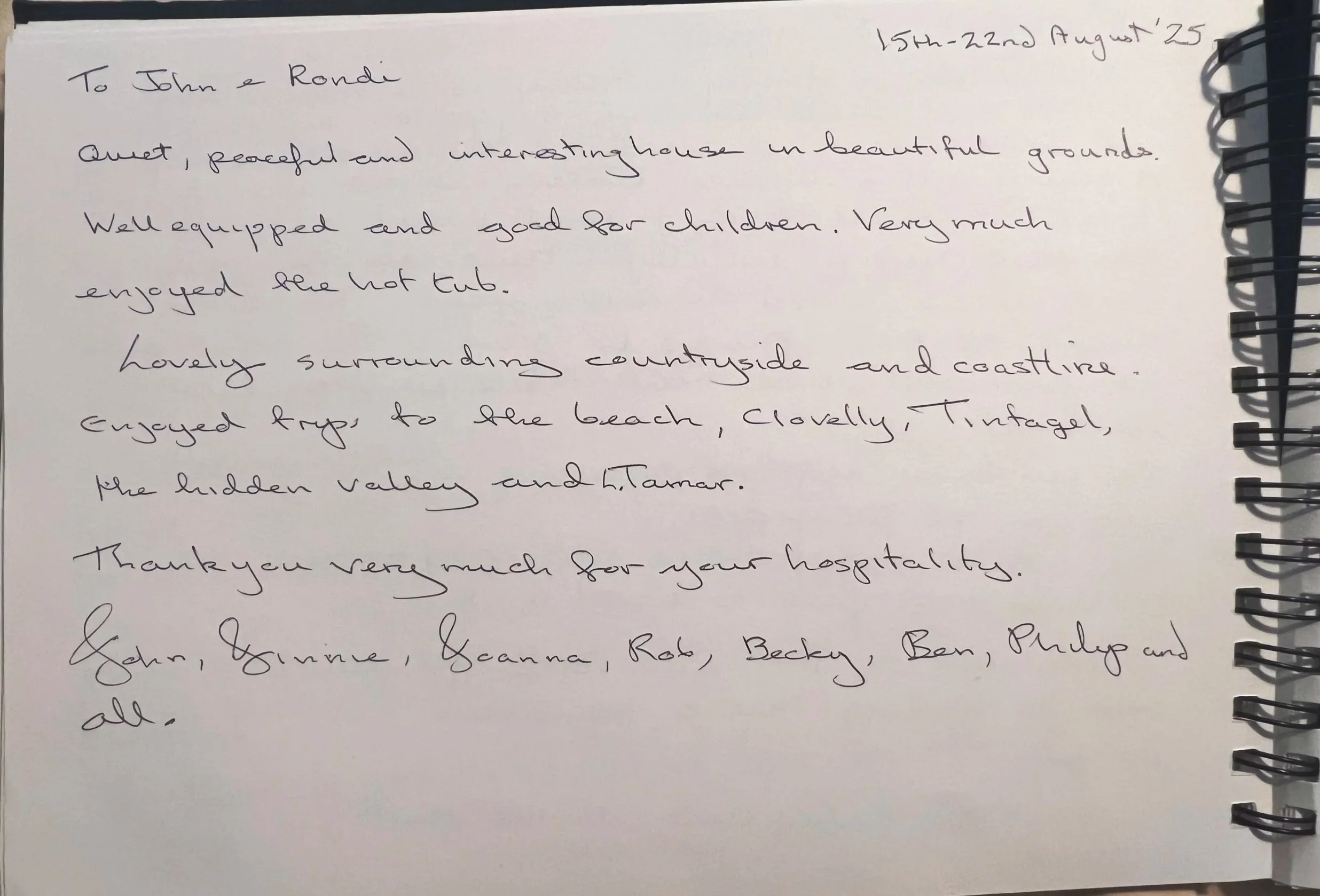 Handwritten letter on white paper, dated August 25, addressed to John and Rondi, describing a house and its surroundings, including a hot tub, countryside, beach trips, and gratitude at Parnacott house.