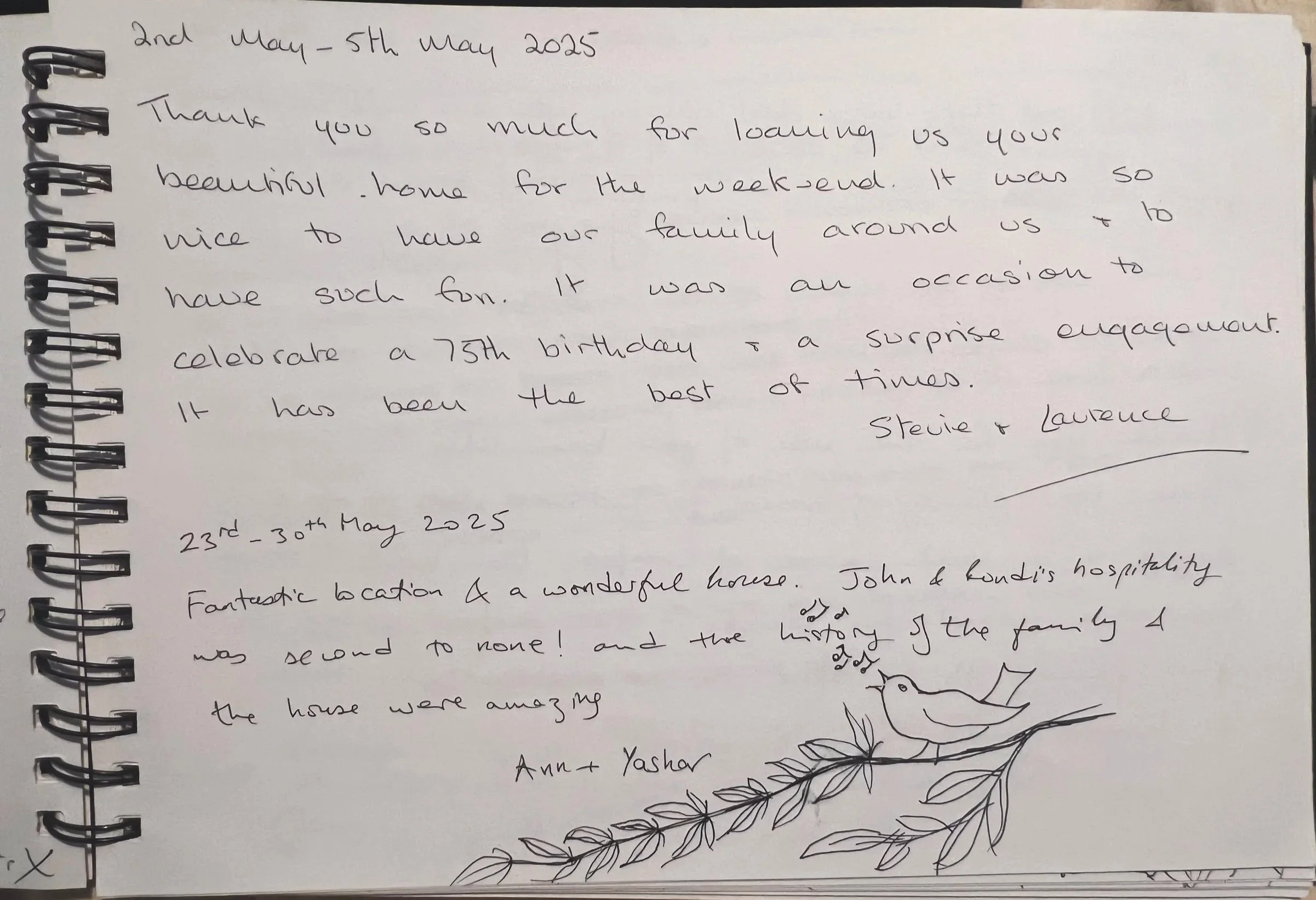 Handwritten note with dates 2nd-5th May 2025 and 23rd-30th May 2025. The note thanks someone for hosting and mentions celebrations for a 75th birthday, a trip to a beautiful house, and the joy of being together with family. There is a small drawing of a bird on a branch at the bottom of the page.