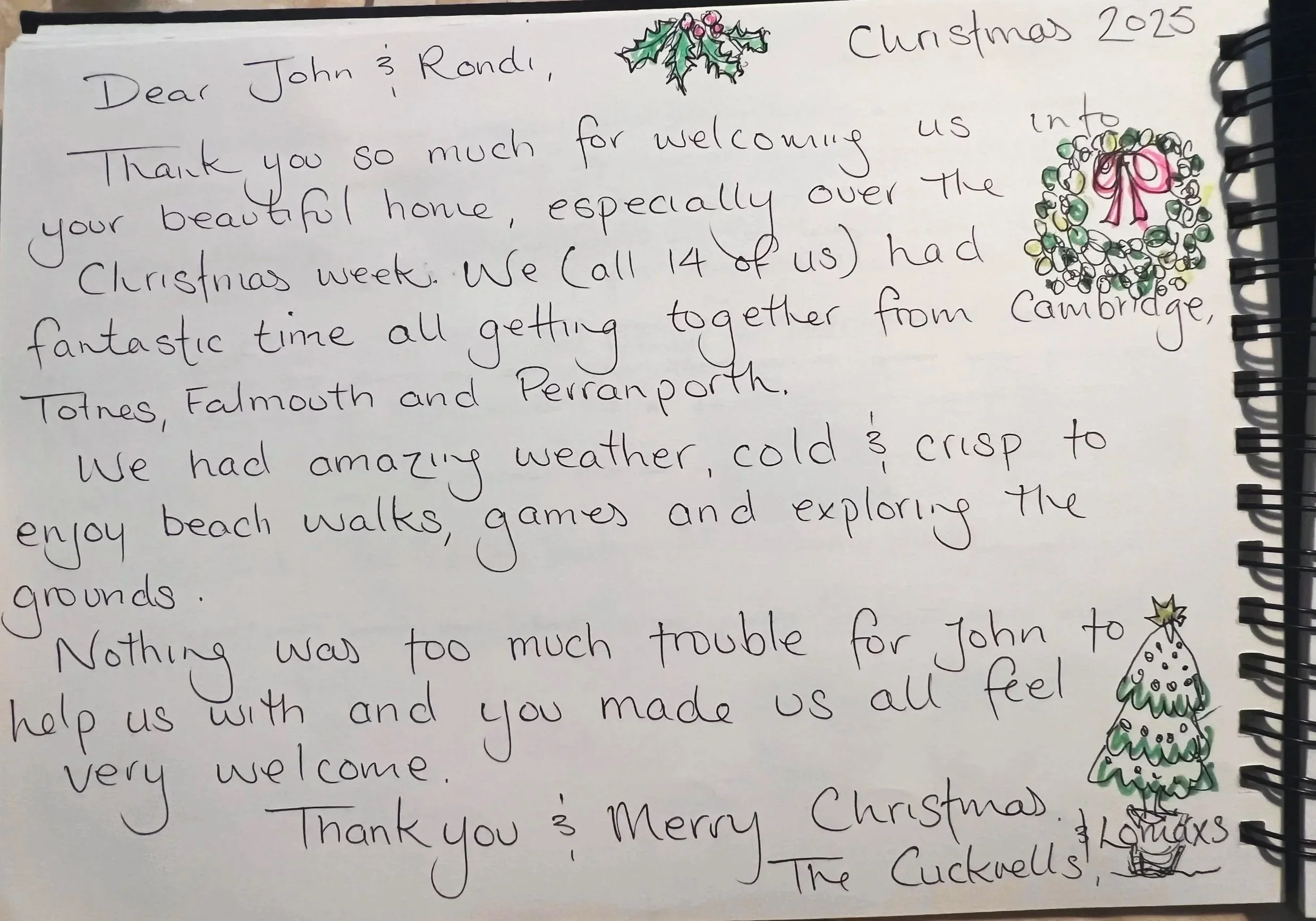 Handwritten Christmas thank you letter with doodles of holly, Christmas tree, and a snowman on a spiral-bound notebook at Parnacott house.