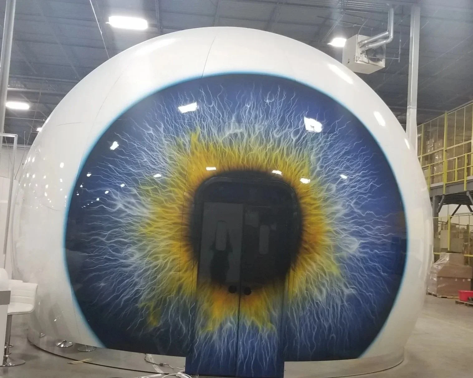 A large spacecraft or aircraft with a detailed and realistic eye design painted on its front, resembling a human iris.
