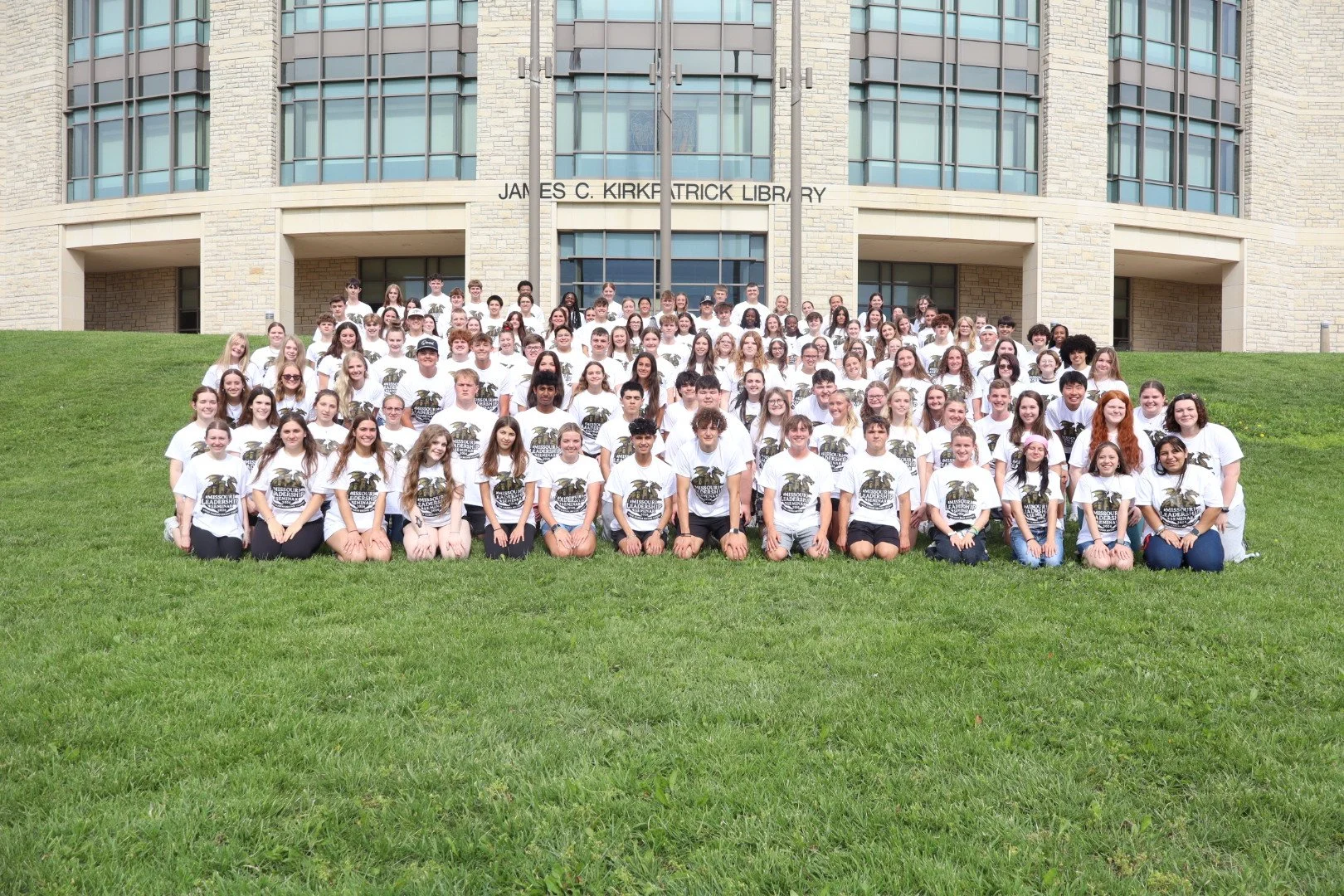 Group photo of Missouri State University students wearing Missouri Leadership Seminar T-shirts outside the James C. Kirkpatrick Library.