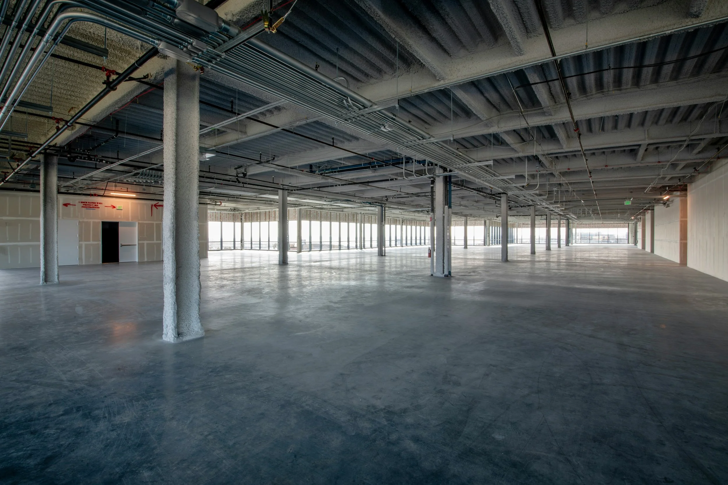 Empty move-in-ready commercial space with polished concrete floors ready for tenant build-out