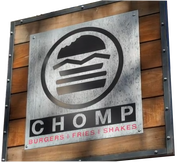HOMP Burger Fries Shakes restaurant sign mounted on a wooden wall
