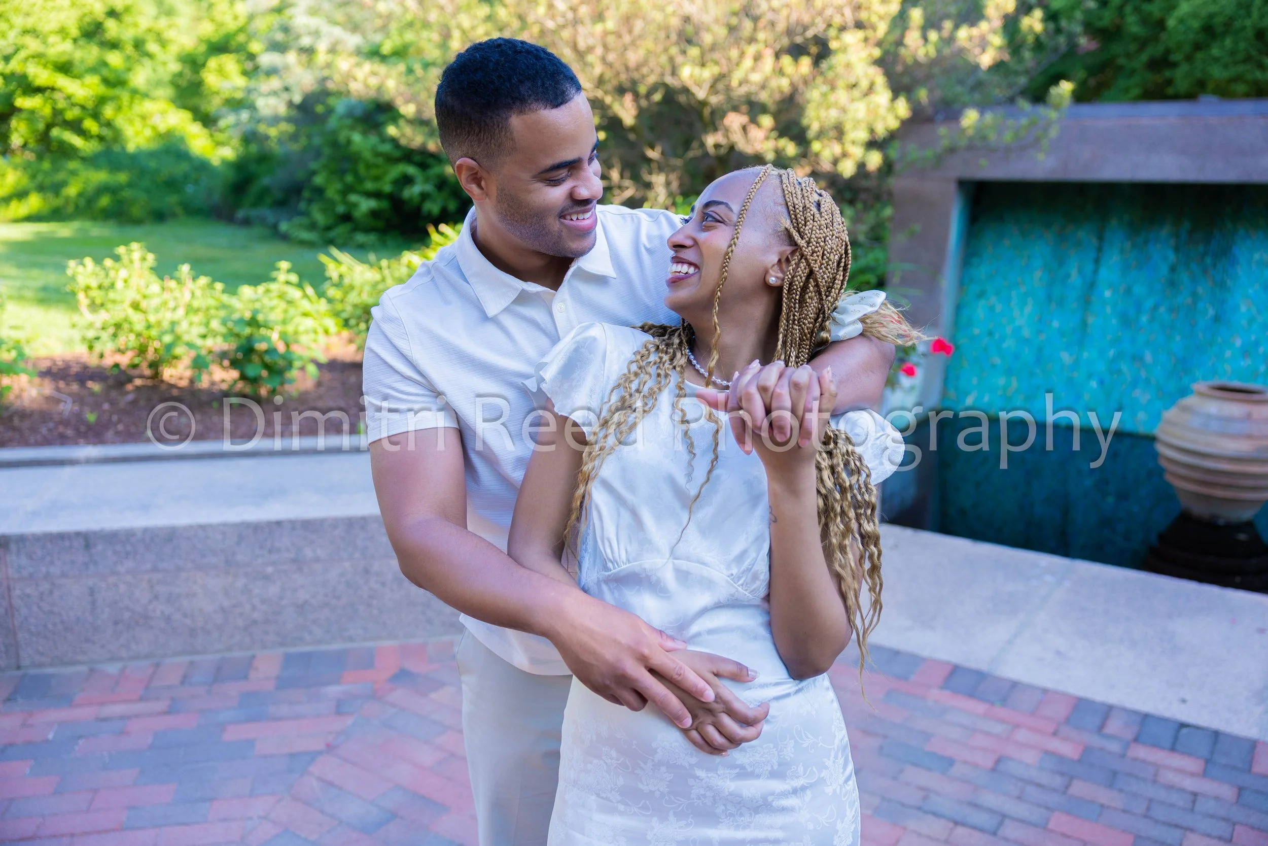 A couple in love sharing an intimate embrace outdoors on a sunny day.