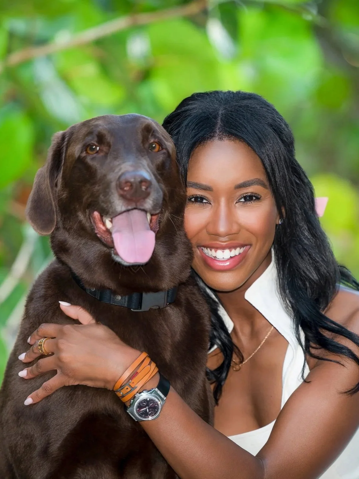 Woman hugging her chocolate Labrador among tropical greenery, people and pets photography