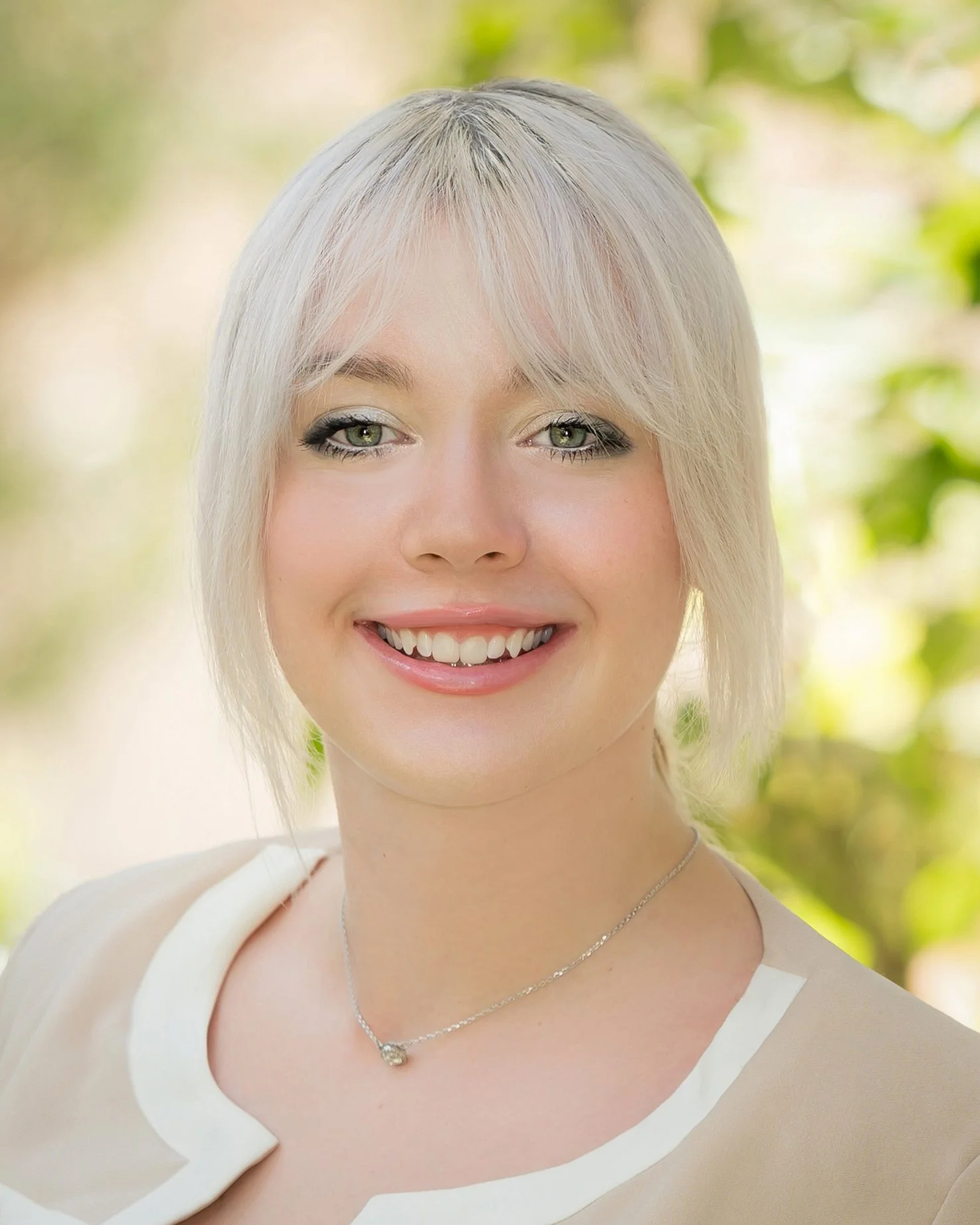 Natural light outdoor headshot of a young woman with platinum hair, personal branding portrait South Florida