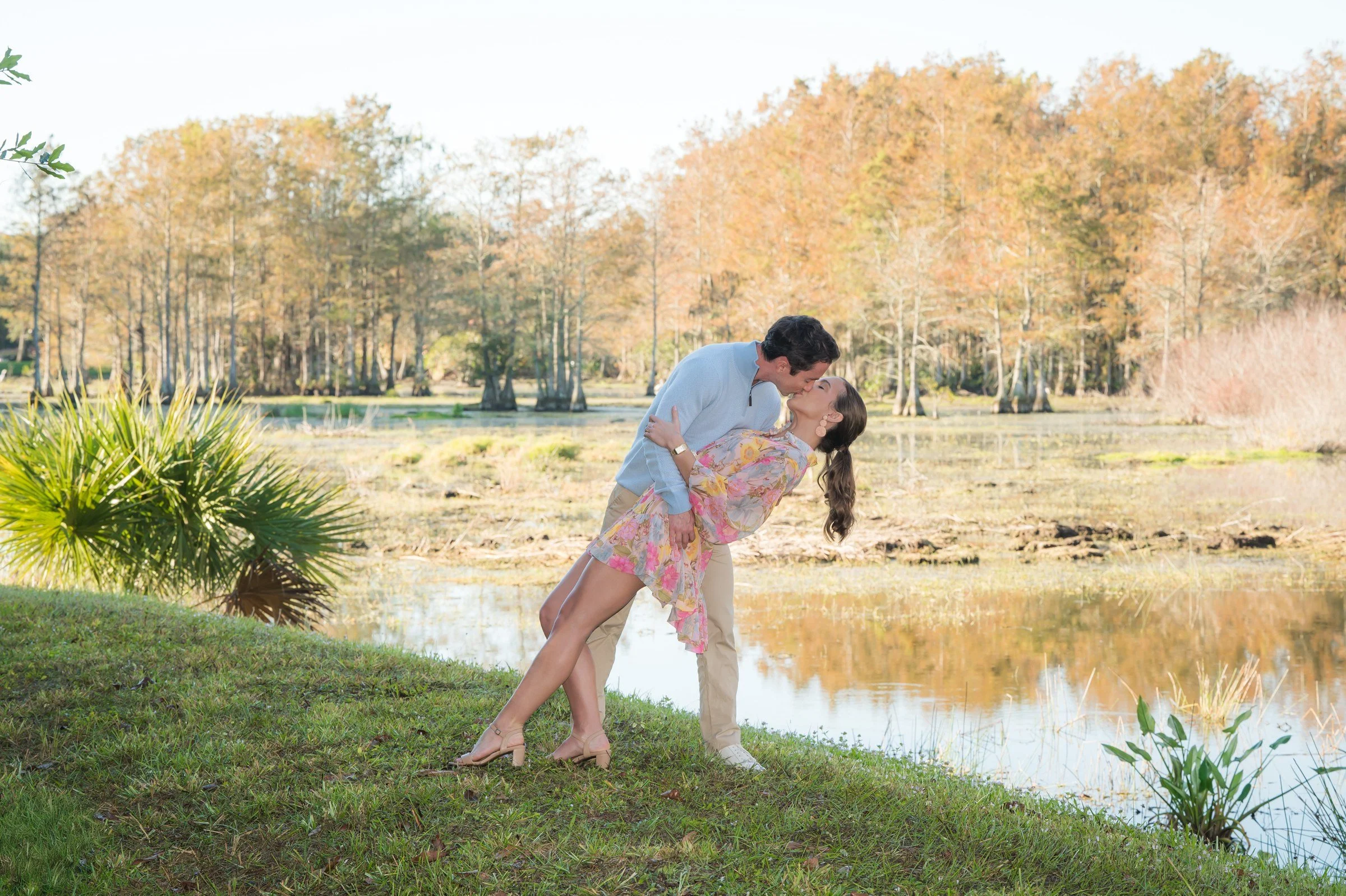 Couple dancing by a lake at golden hour, romantic outdoor couples photography South Florida
