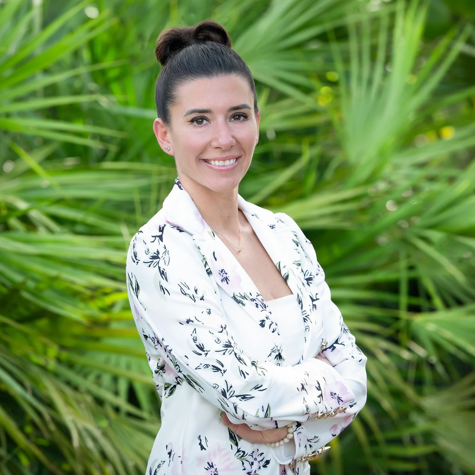 Outdoor professional portrait of a businesswoman in a floral blazer among tropical palms, South Florida headshots