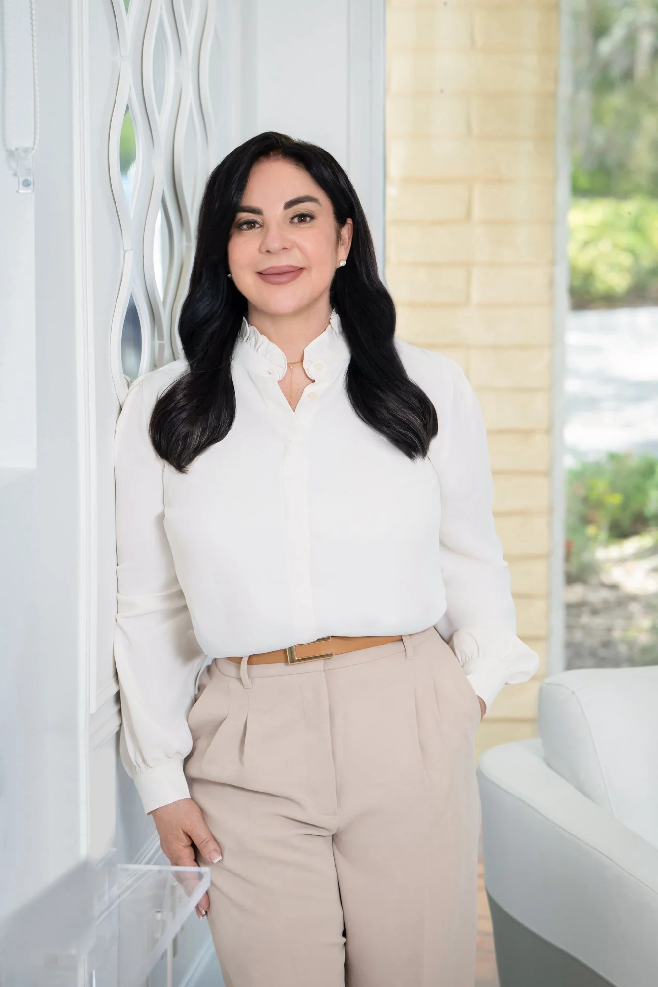Modern personal branding portrait of a businesswoman in a white blouse in a stylish interior, Vasi Studio