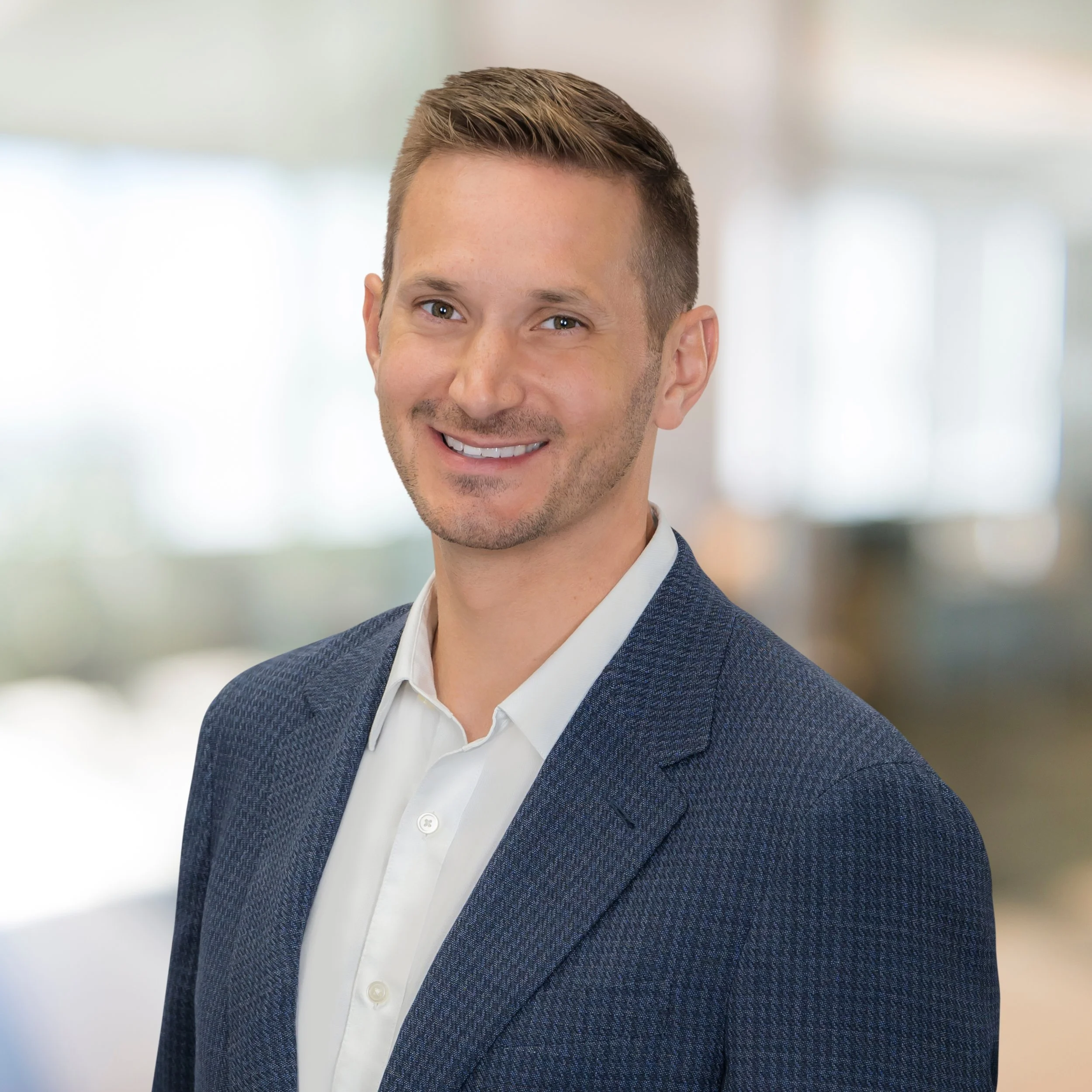 Professional headshot of a man in a navy blazer in a bright modern office, LinkedIn headshot Palm Beach Gardens