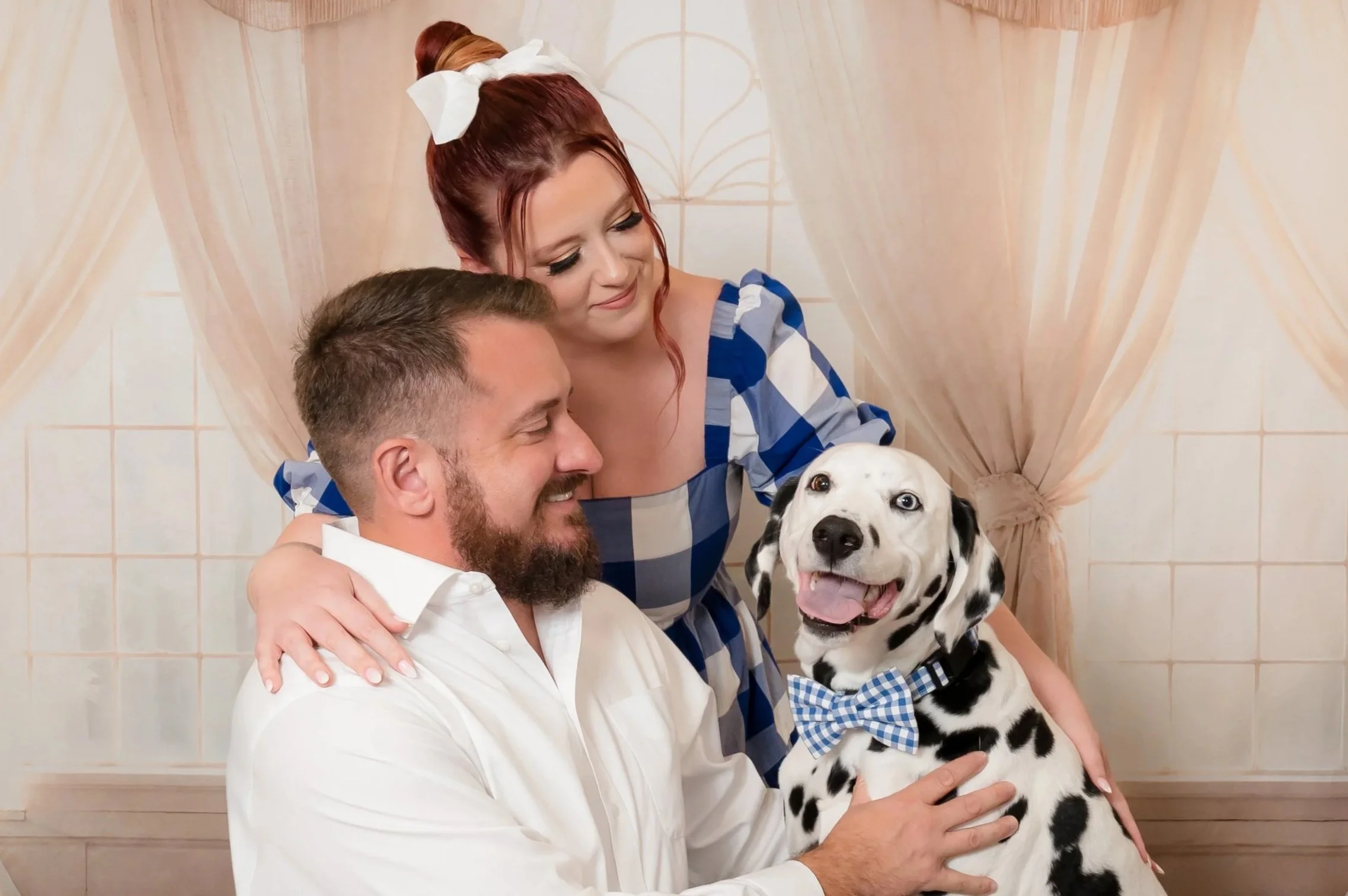 Couple with their Dalmatian in a soft white studio setting, people and pets portrait in Palm Beach Gardens