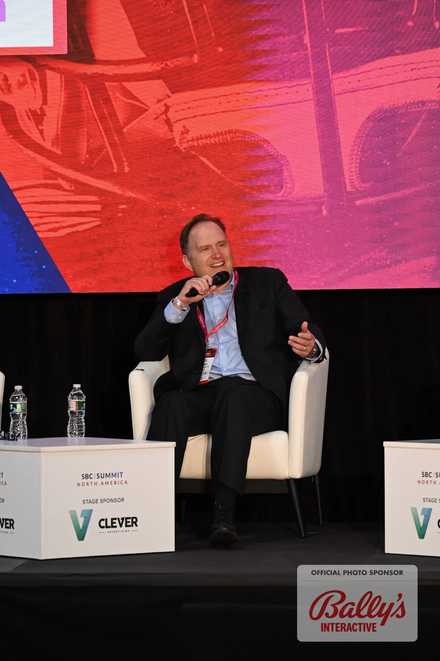 Jamison Selby speaking on stage at a gaming industry conference