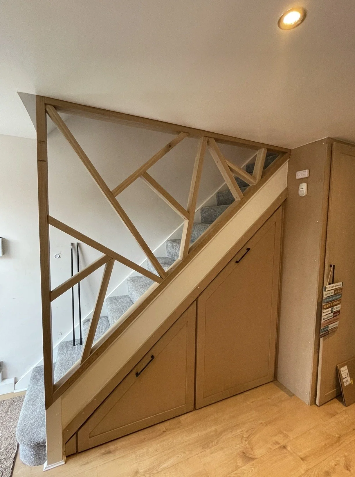 Bespoke staircase rail banister, bespoke MDF storage, stair storage solutions, staircase cupboards, geometric staircase, American white oak, natural solid oak