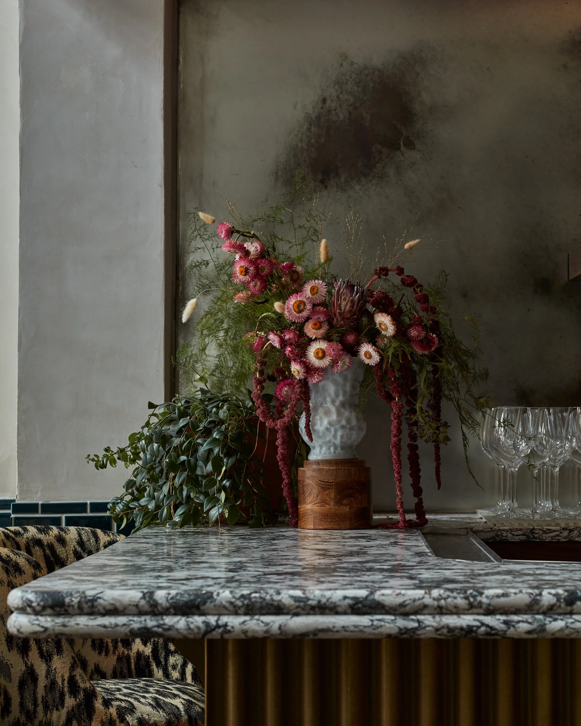 quart cambria coutertops in busy black and white pattern and imaginative flower arrangement