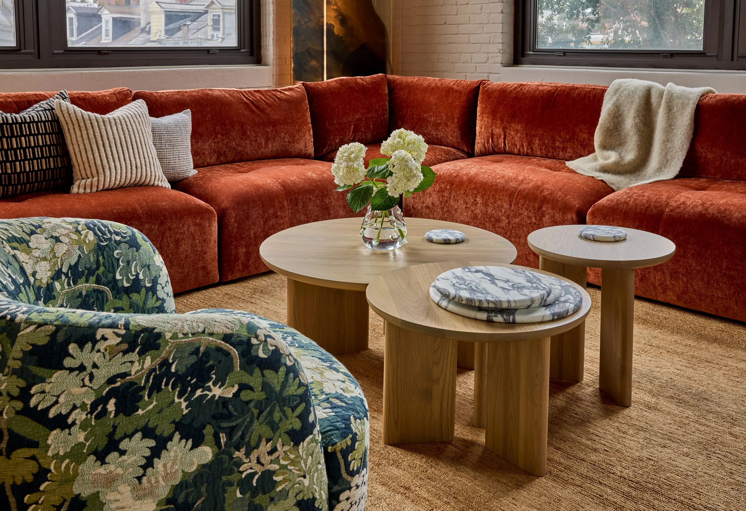 living room furnishings include wood coffee table and an orange sofa