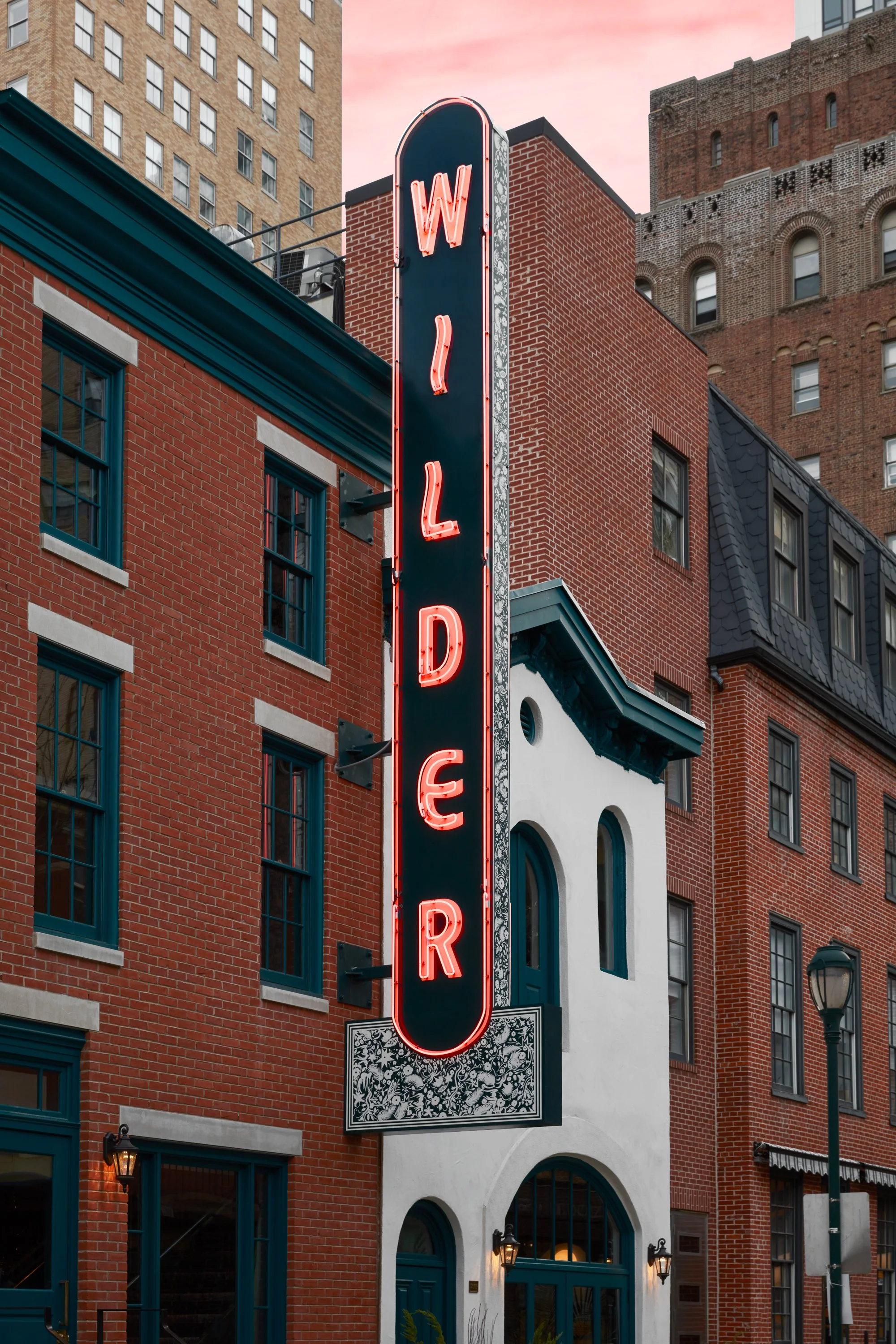 wilder restaurant's facade designed by velocette studio features rehabilitated historical building and huge neon signage
