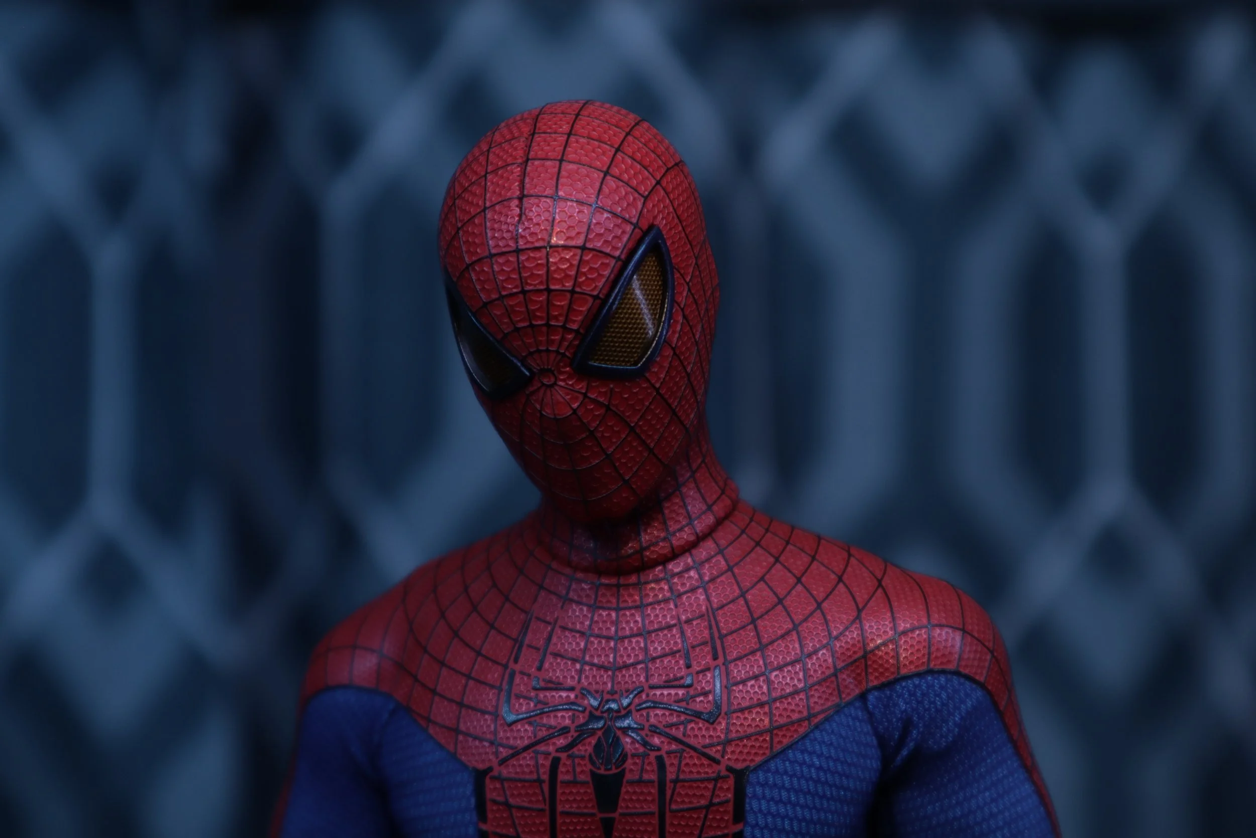 Close-up of Spider-Man wearing his red and blue costume with web patterns and a spider emblem, looking directly at the camera.