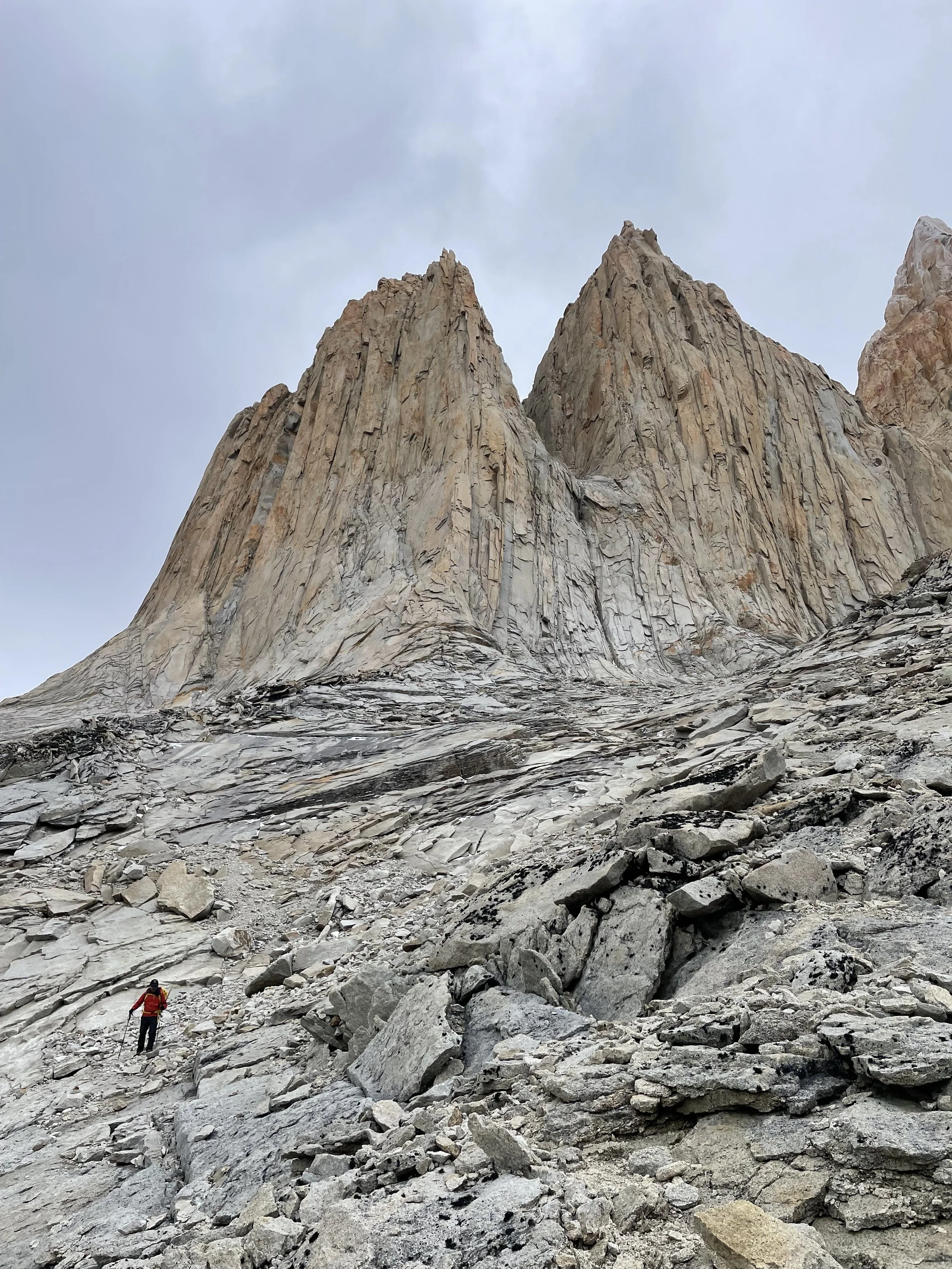 Climber below the North Tower of Paine, on a guided climbing trip with Paine Mountain Guides, a locally owned and operated guides company that run many different trips in Torres del Paine, in Chilean patagonia.
