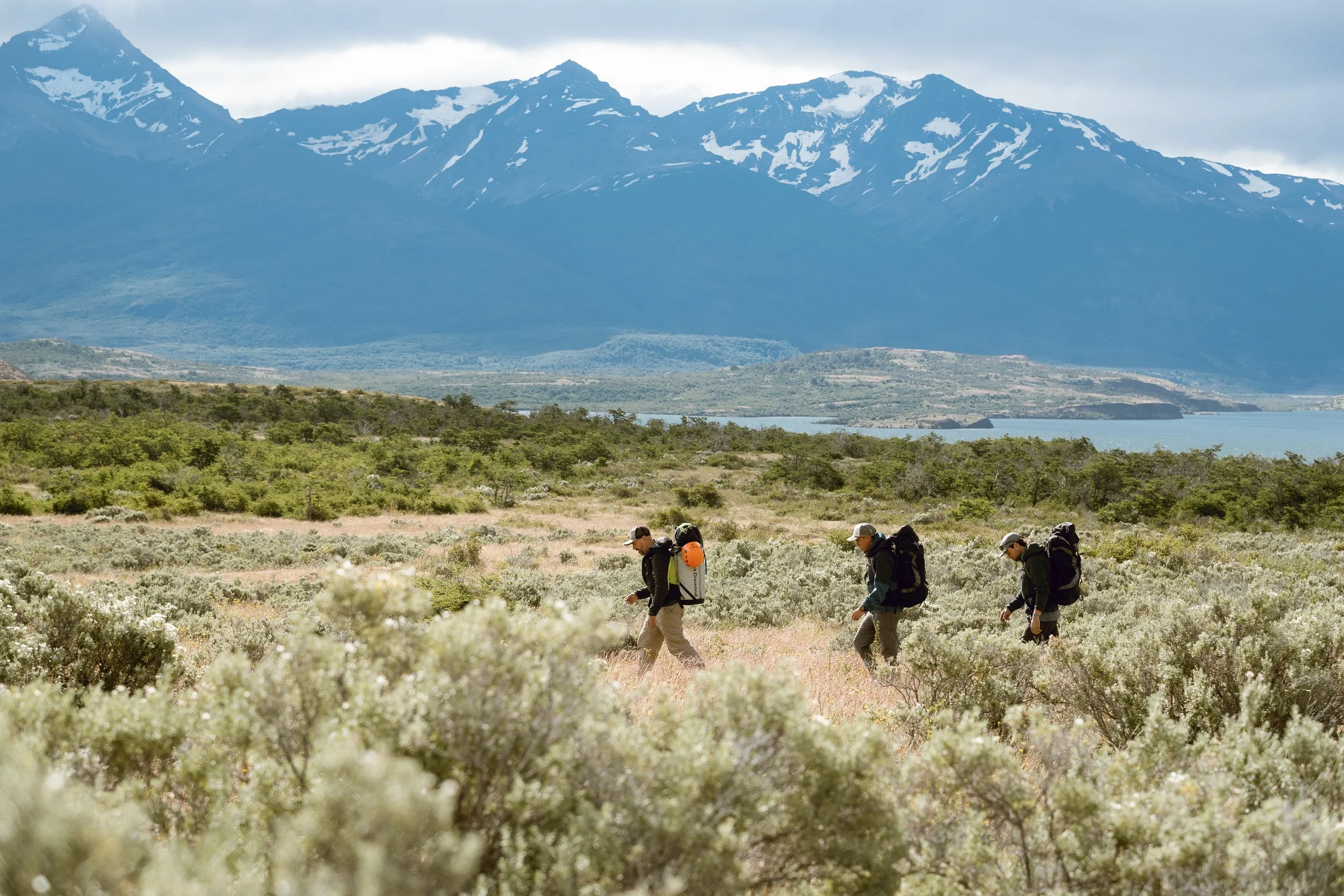 Four guests approaching the rock climbing area at laguna sofia, on a guided climbing trip with Paine Mountain Guides, a locally owned and operated guides company that run many different trips in Torres del Paine, Chilean Patagonia.