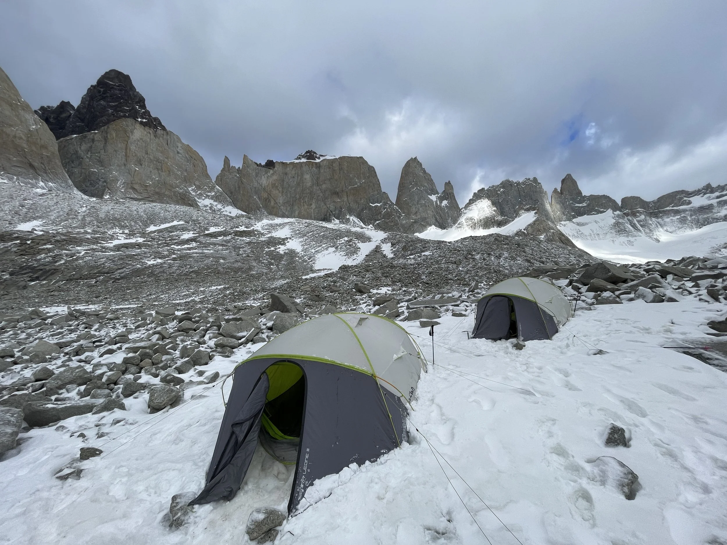 A climber in base camp in the Bader Valley, on the Roller Coaster Traverse, on a guided climbing trip with Paine Mountain Guides, a locally owned and operated guides company that run many different trips in Torres del Paine, Chilean Patagonia.