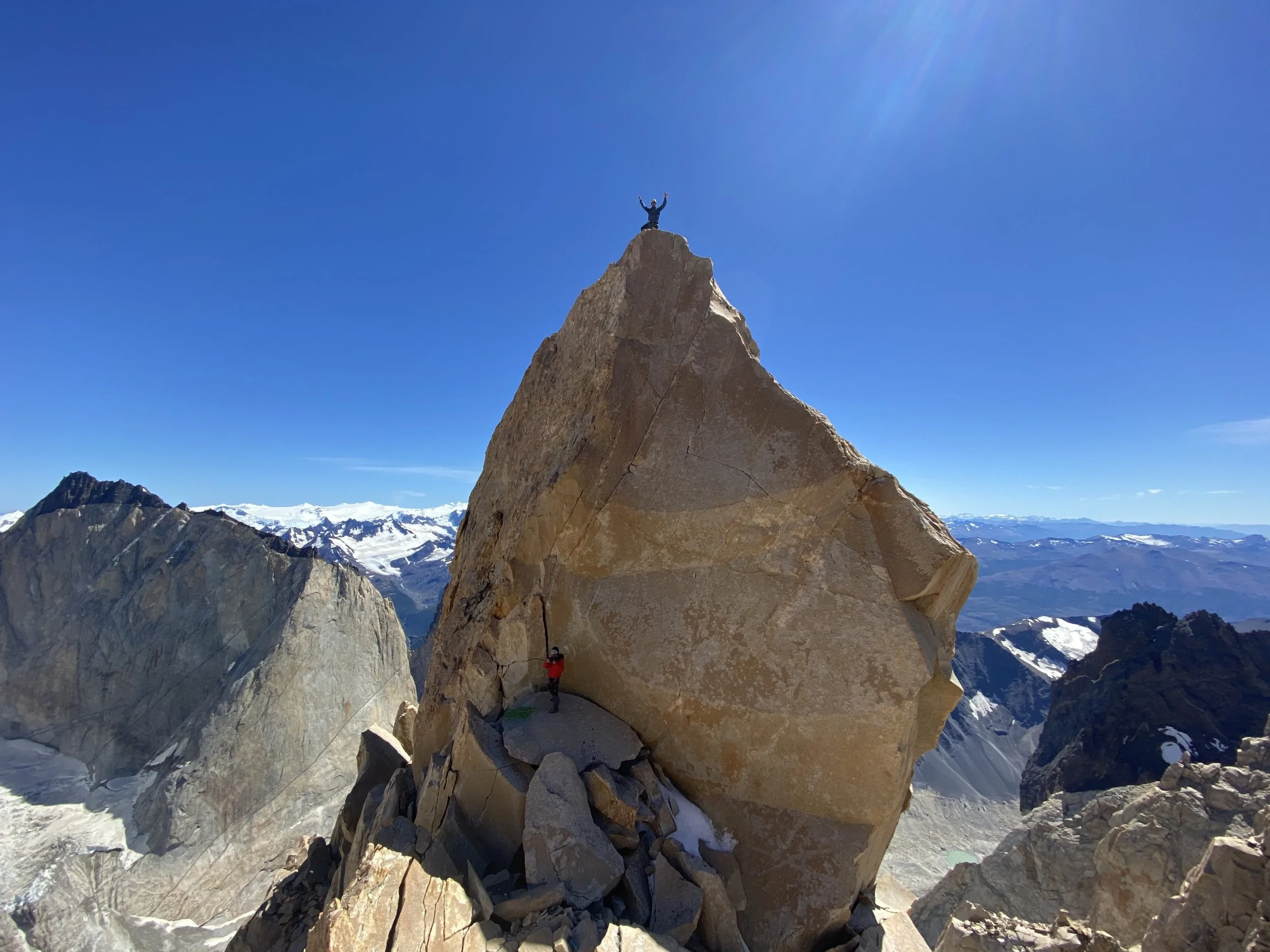 A climber on the summit of the North Tower of Paine, after climbing it on a guided trip with Paine Mountain Guides