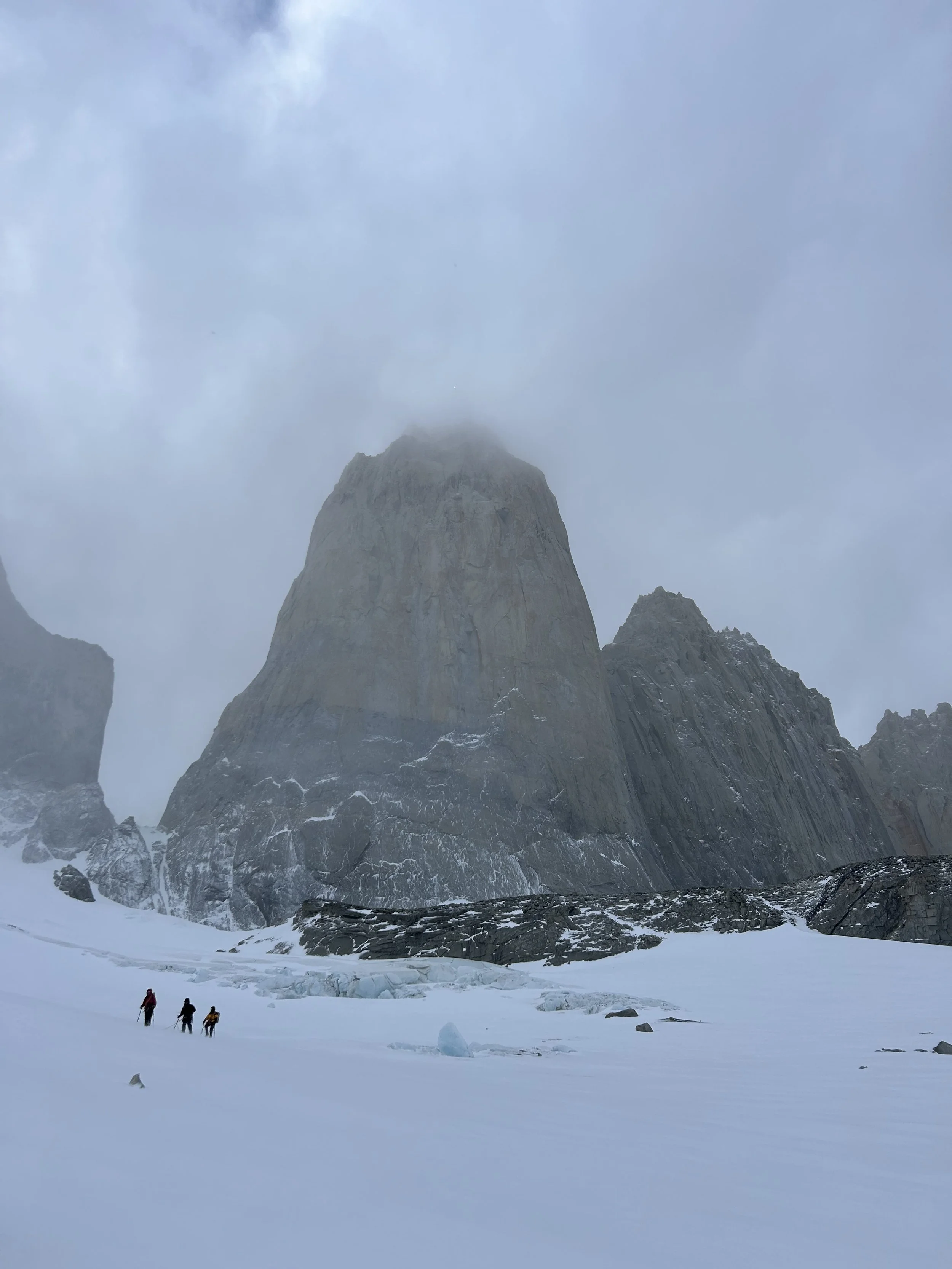Climbers below the Towers of Paine, on a guided climbing trip with Paine Mountain Guides, a locally owned and operated guides company that run many different trips in Torres del Paine, in Chilean patagonia.