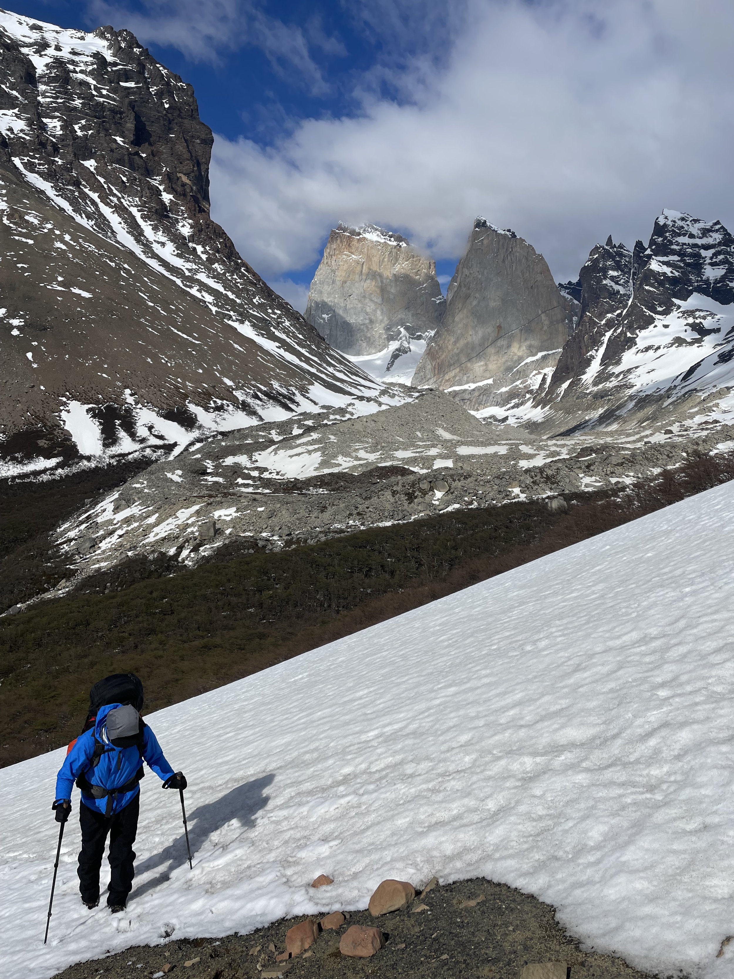 A hiker headed up Paso Oggioni, on a guided climbing trip with Paine Mountain Guides, a locally owned and operated guides company that run many different trips in Torres del Paine, in Chilean patagonia.
