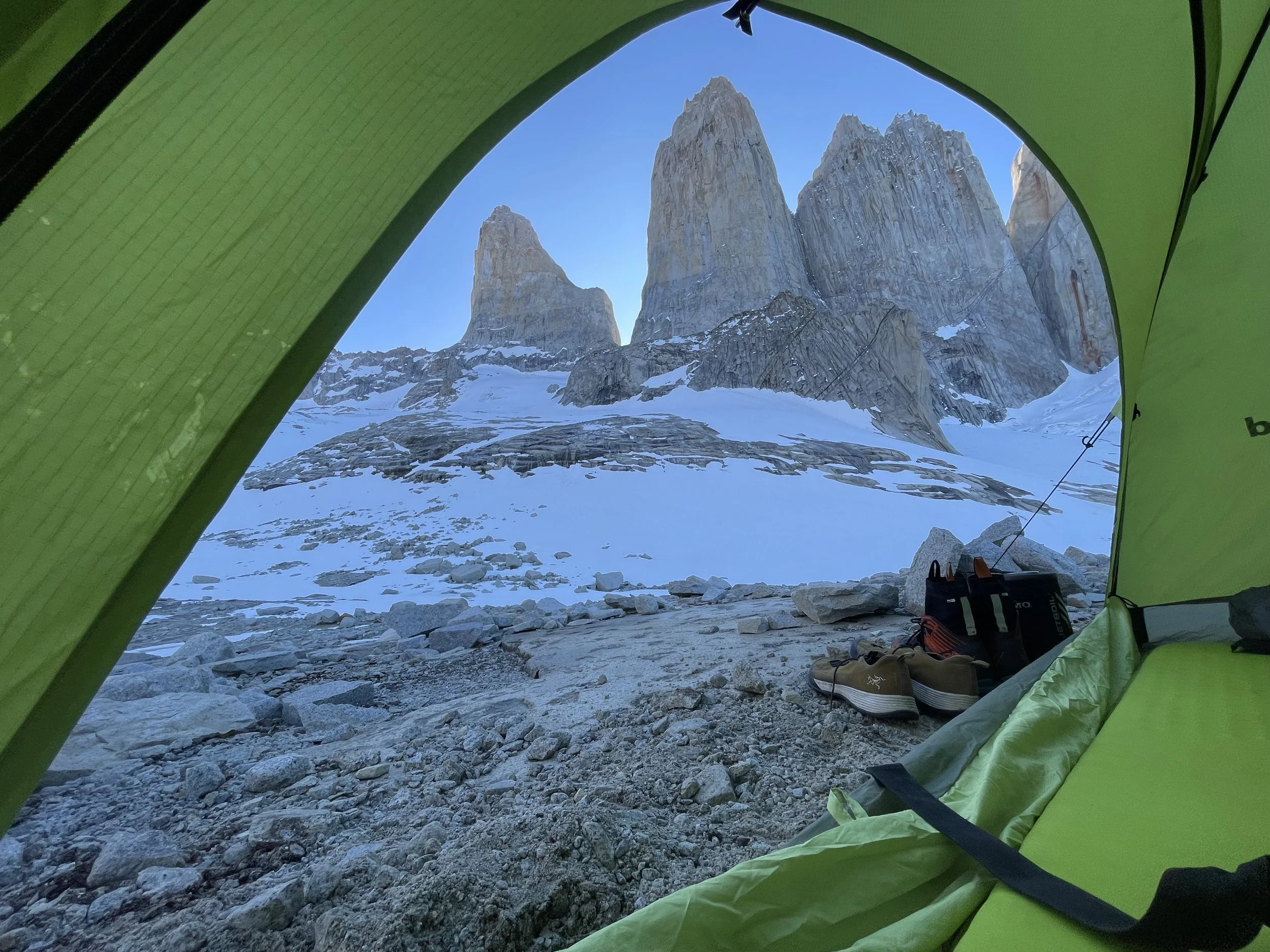 View of the Torres del paine, from a tent, at base camp, on a guided climbing trip with Paine Mountain Guides, a locally owned and operated guides company that run many different trips in Torres del Paine, in Chilean patagonia. 