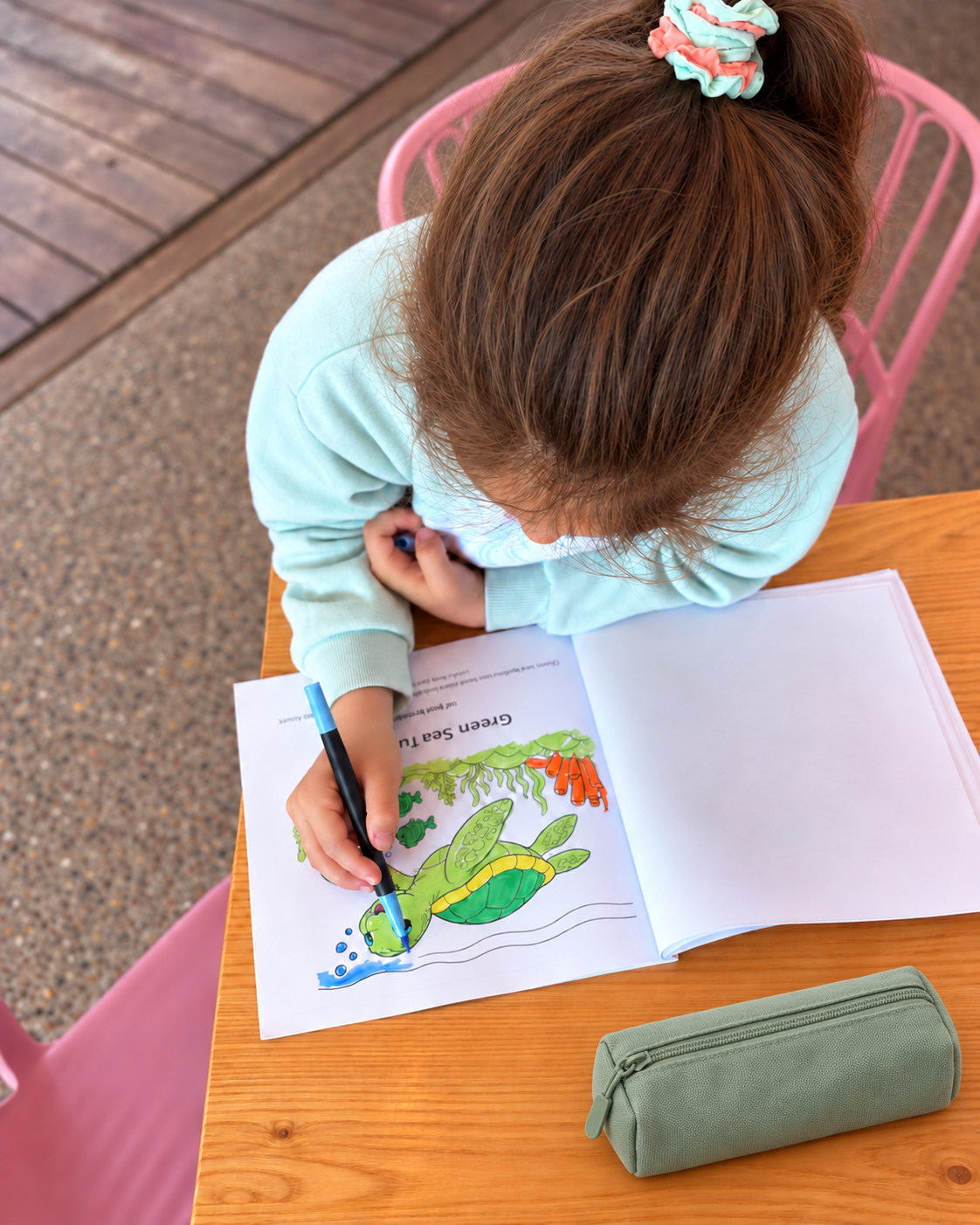 A child colouring the Green Sea Turtle page from Little Aussie Adventures