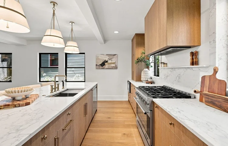 Kitchen with marble counters, a professional range and wood cutting boards