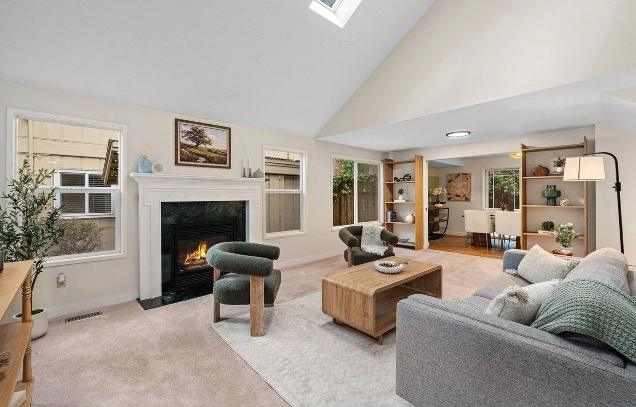 Cozy vaulted living room with a fireplace and sage boucle chairs