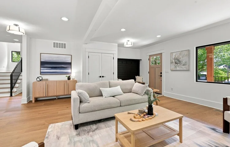 New-construction living room with a cream sofa and oak coffee table