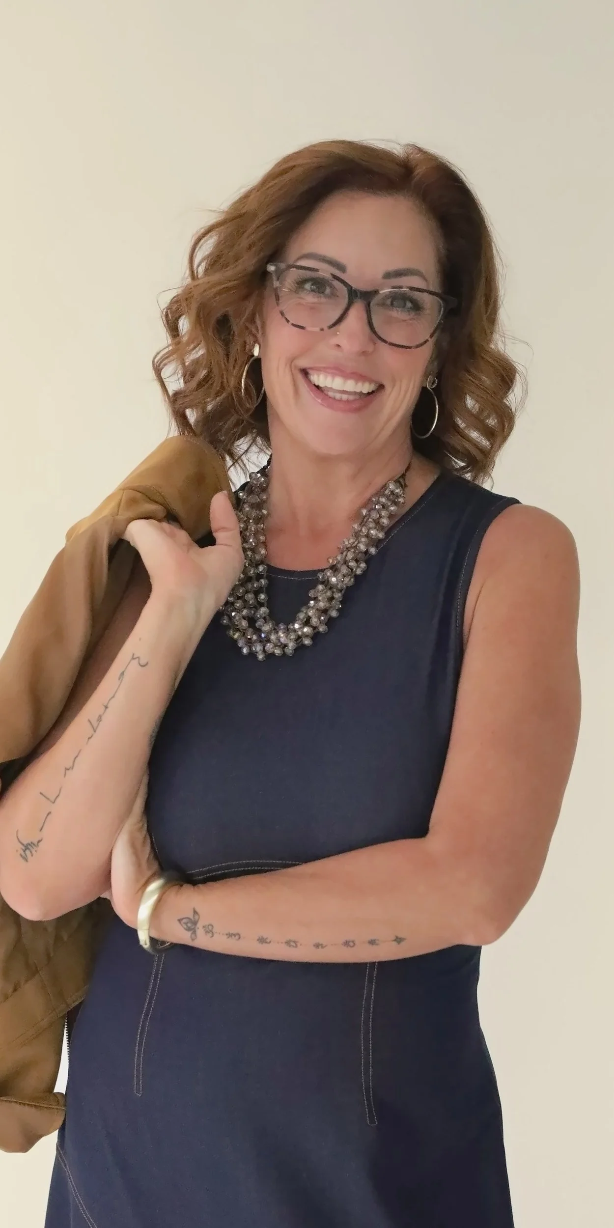Wende Valentine smiling, jacket over her shoulder