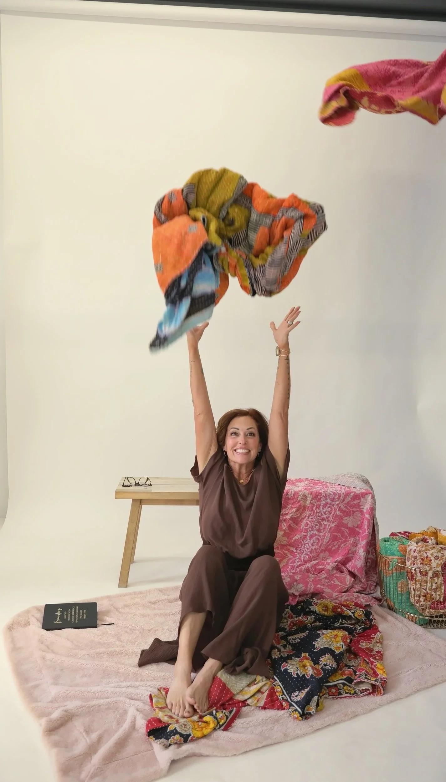 Wende Valentine joyfully tossing colorful blankets into the air