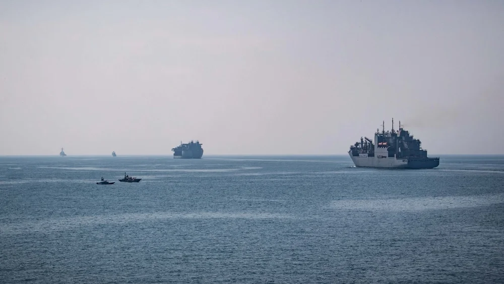 Iranian small boats operating near U.S. Navy vessels during a transit of the Strait of Hormuz.