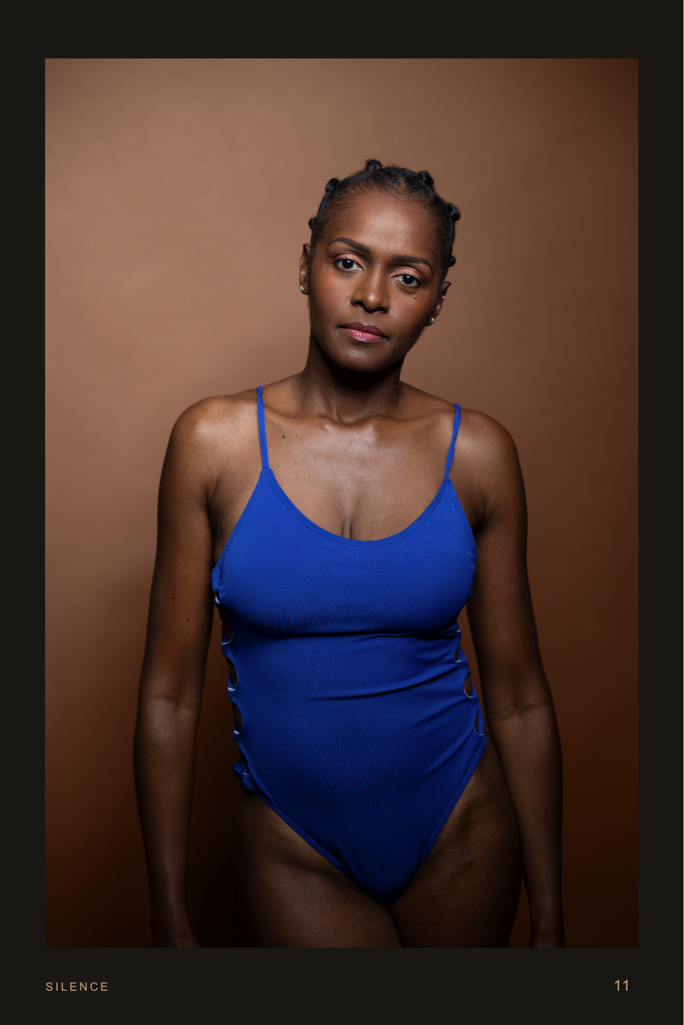 Strength In Grace, page 11. She meets the viewer in a close blue-bodysuit portrait.