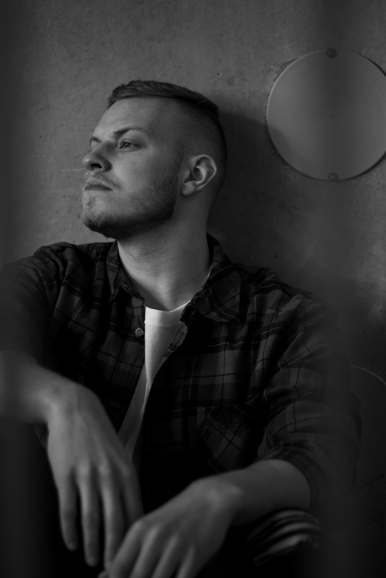 Presence, page 7. He turns toward the light in a reflective monochrome portrait.