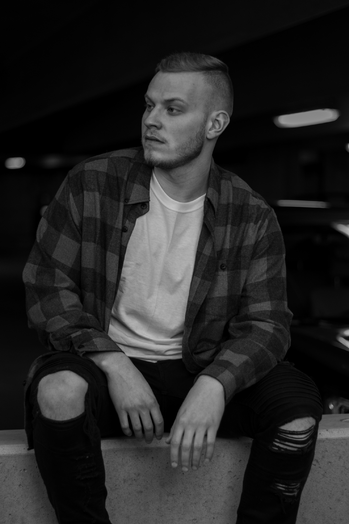 Presence, page 11. Seated on the steps, he looks beyond the camera.