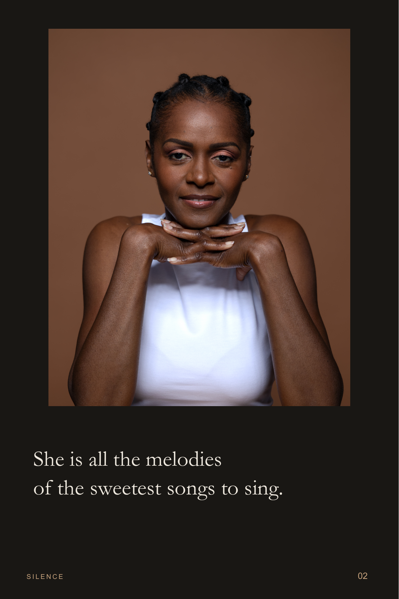Strength In Grace, page 2. Hands beneath her chin, she meets the camera in a white top. Page text: She is all the melodies of the sweetest songs to sing.