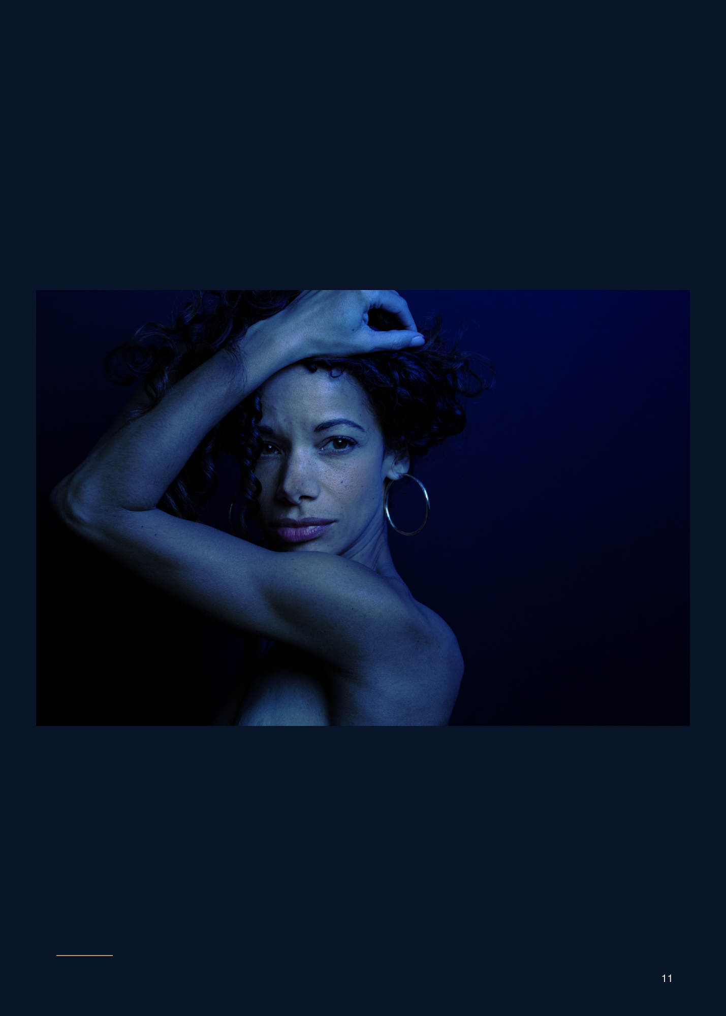 After Dark, page 11. She looks toward the camera, her curls and raised arm framing her face.