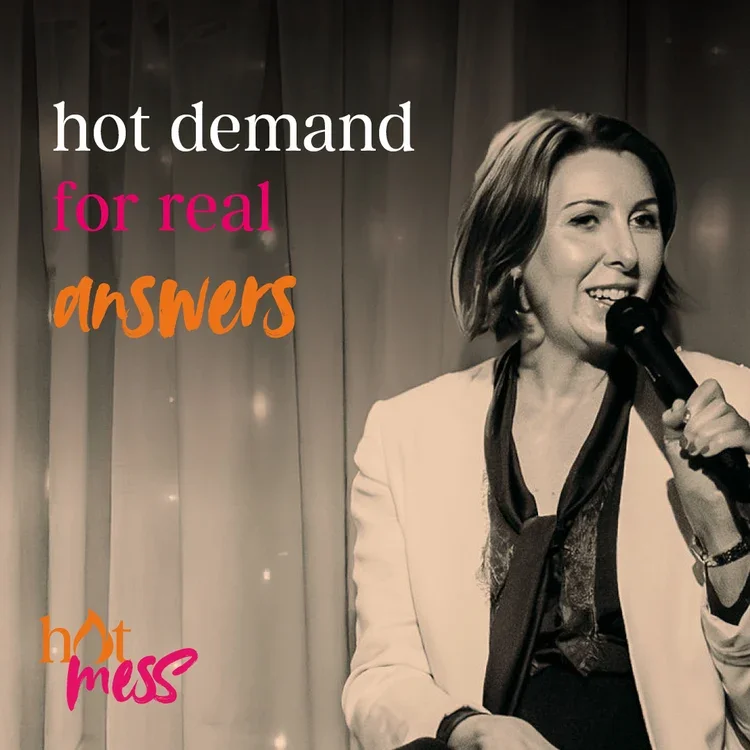A woman holding a microphone on stage with curtains in the background. The image has text that says 'hot demand for real answers' and 'hot mess' in colorful fonts.