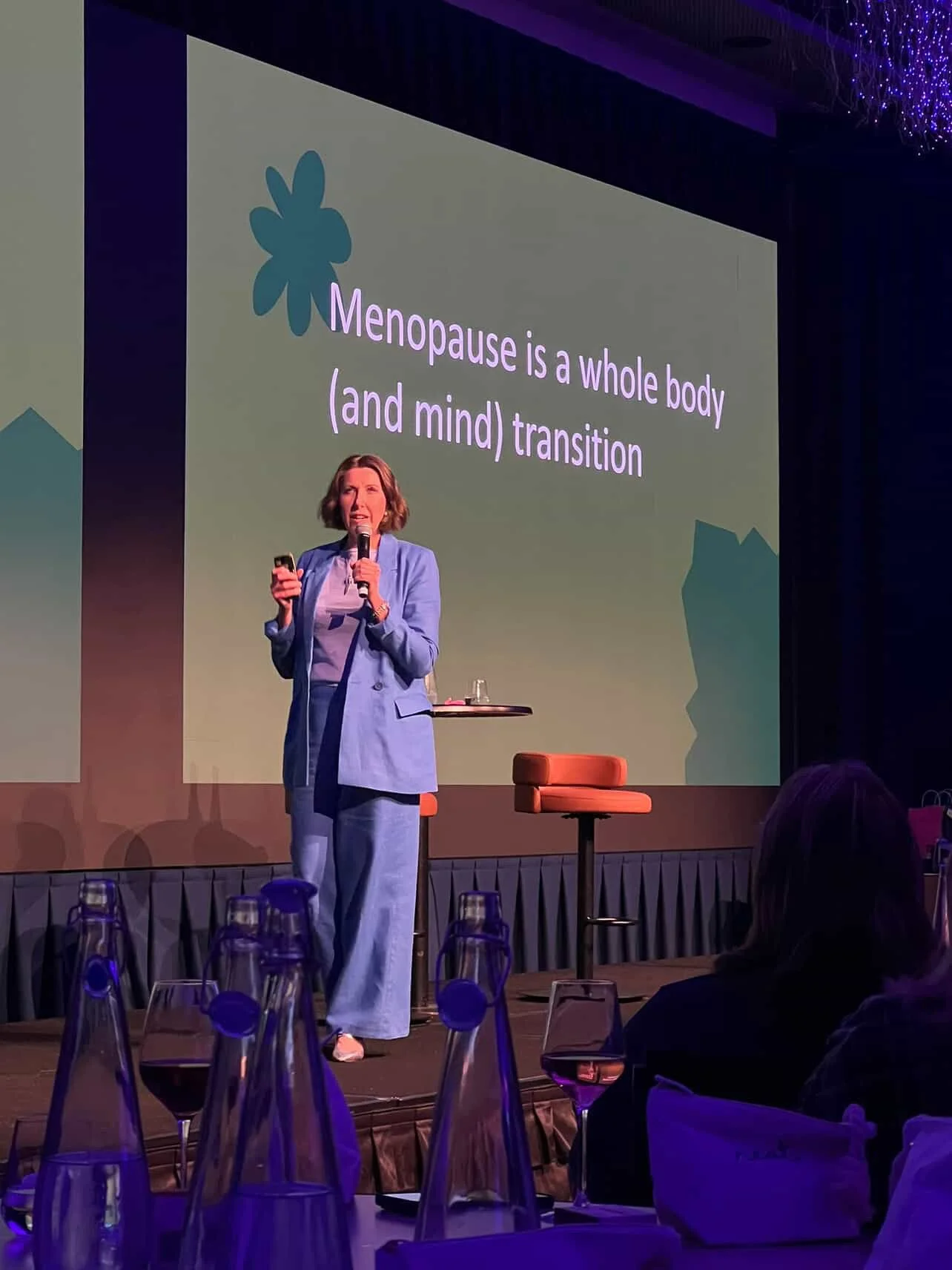 Niki Bezzant speaking onstage at a This Changes Everything: the menopause talk