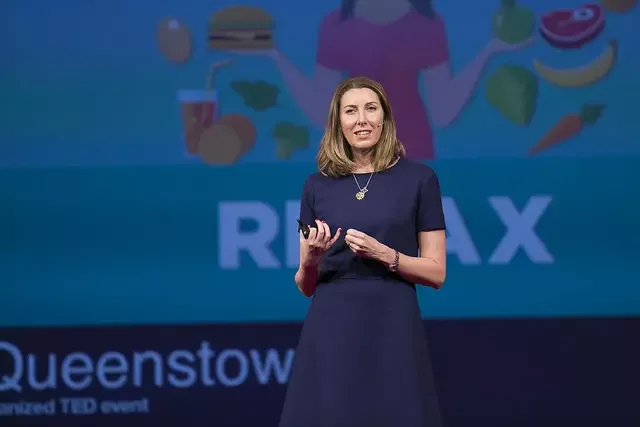 Niki Bezzant speaking onstage at a This Changes Everything: the menopause talk