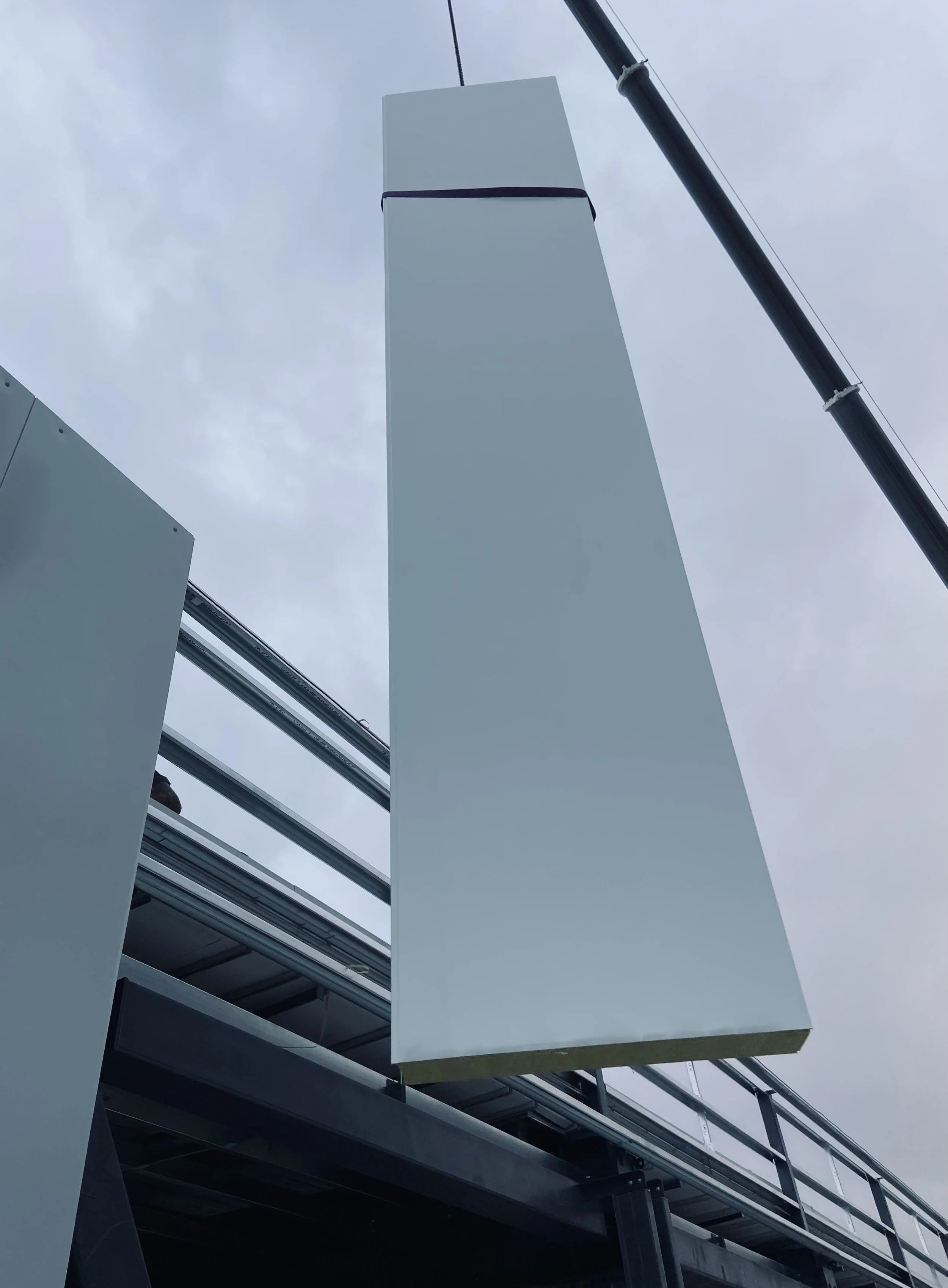 A crane lifting insulated panels